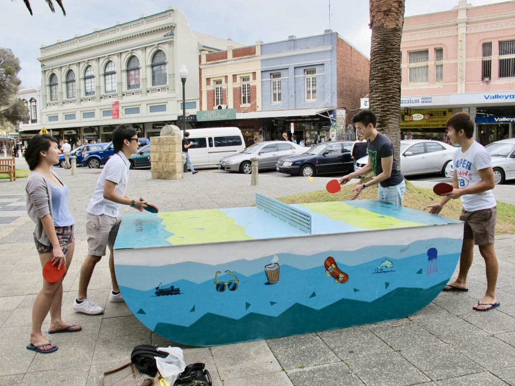  People playing ping pong in Kings Square, 2011 | Marlene Oostryck (Wiki Takes Fremantle participant) - Uploaded from Wiki Takes Fremantle, CC BY 3.0,  https://commons.wikimedia.org/w/index.php?curid=17313403   