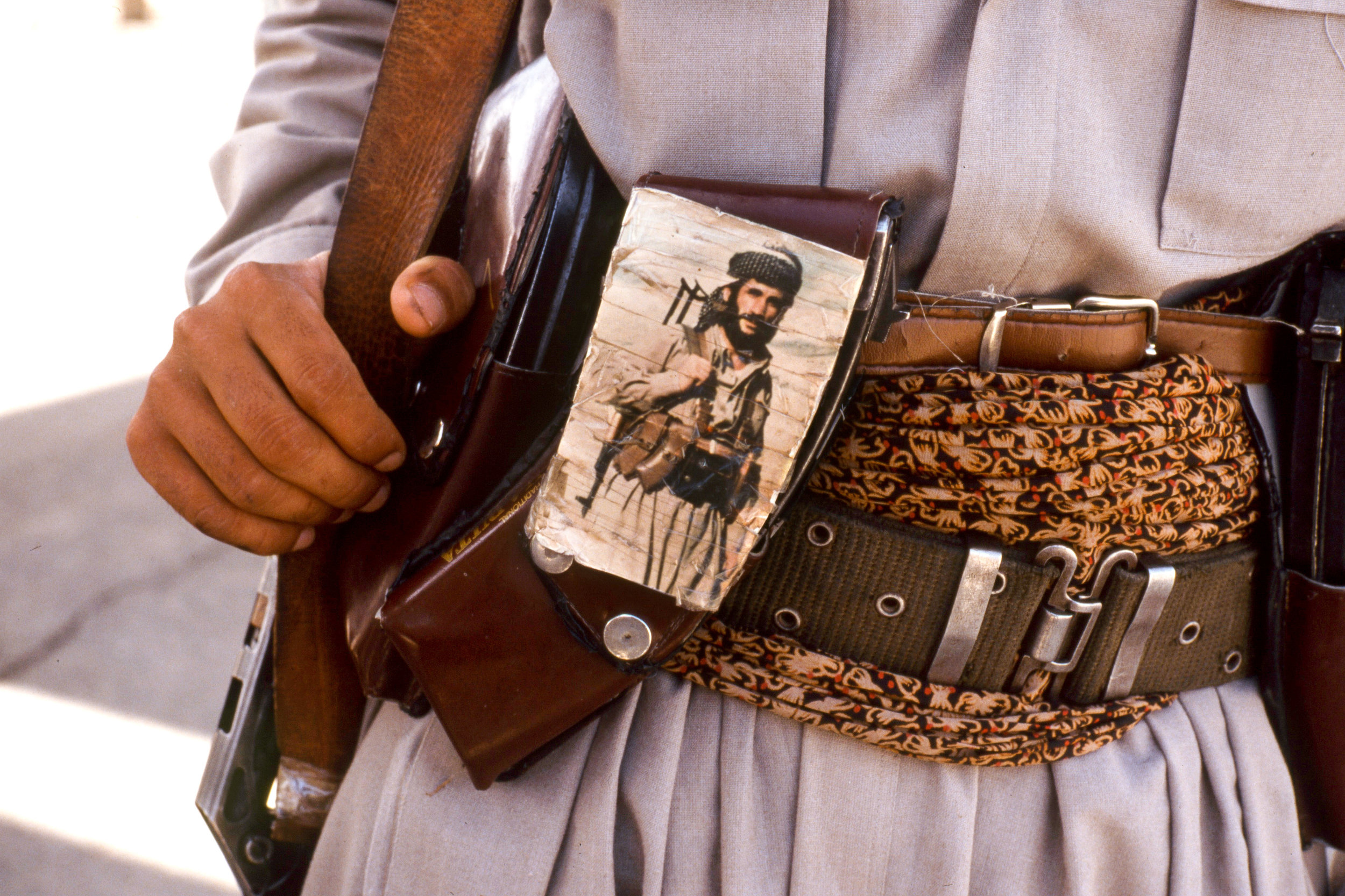 A Peshmerga (Kurdish soldier) wearing a gun belt with a portrait of his brother. Arbil. Northern Iraq. Kurdistan