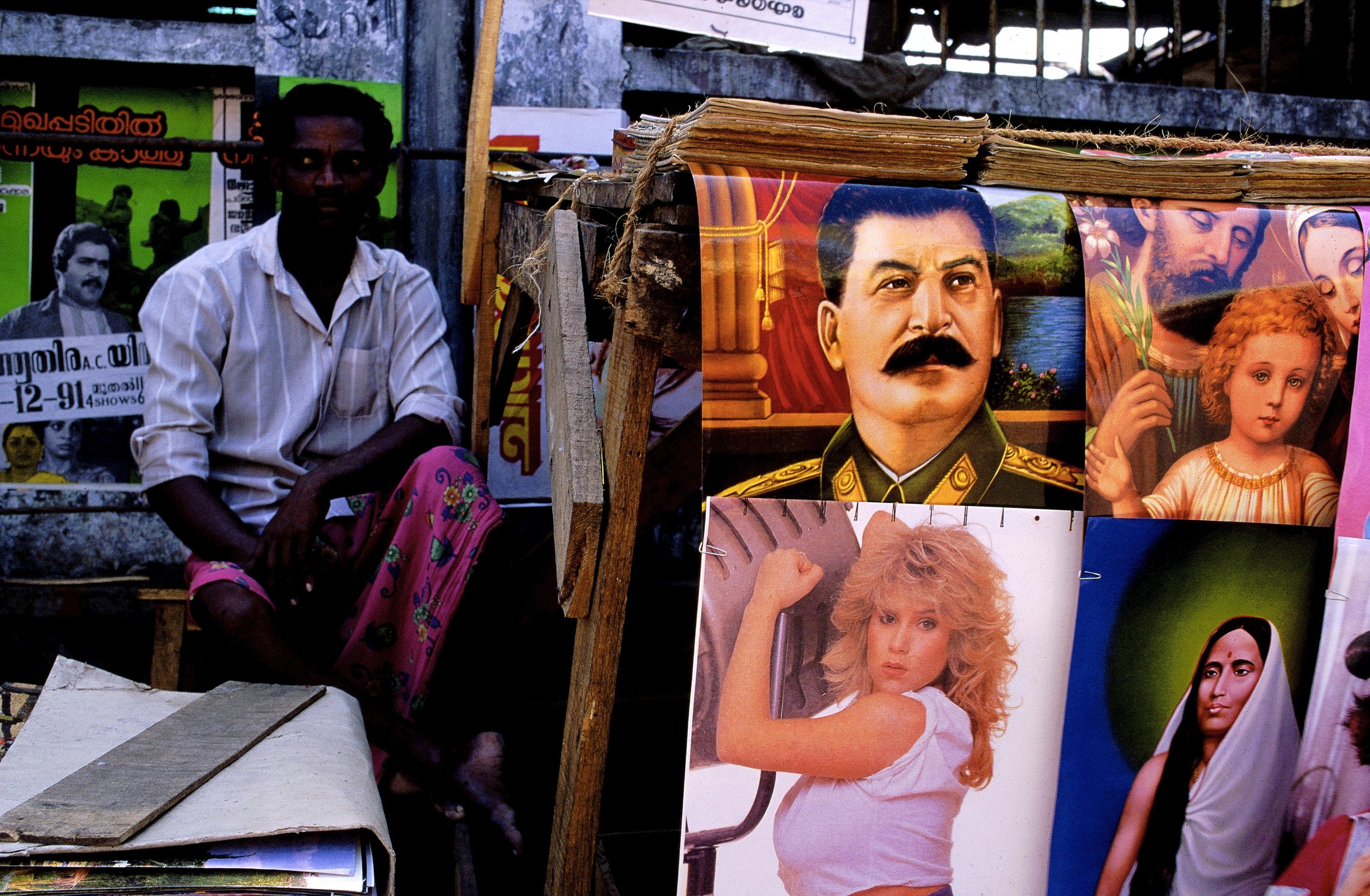 Stall selling posters of Samantha Fox, Stalin, John the Baptist and a local deity. Thiruvananthapuram, (T rivandrum). Kerala. India.