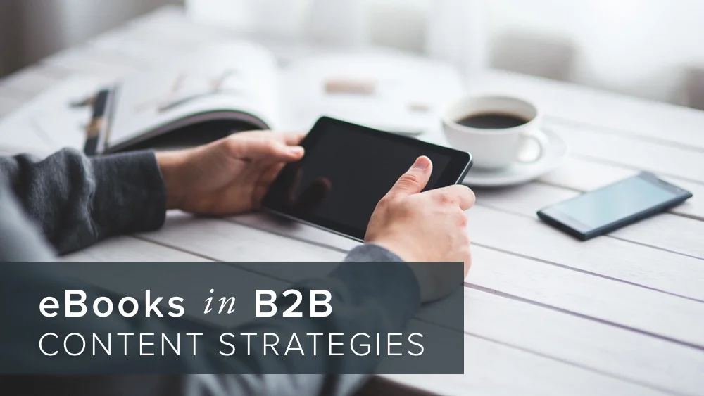 'ebooks+in+b2b+content+strategies'+over+image+of+man+holding+tablet.jpg