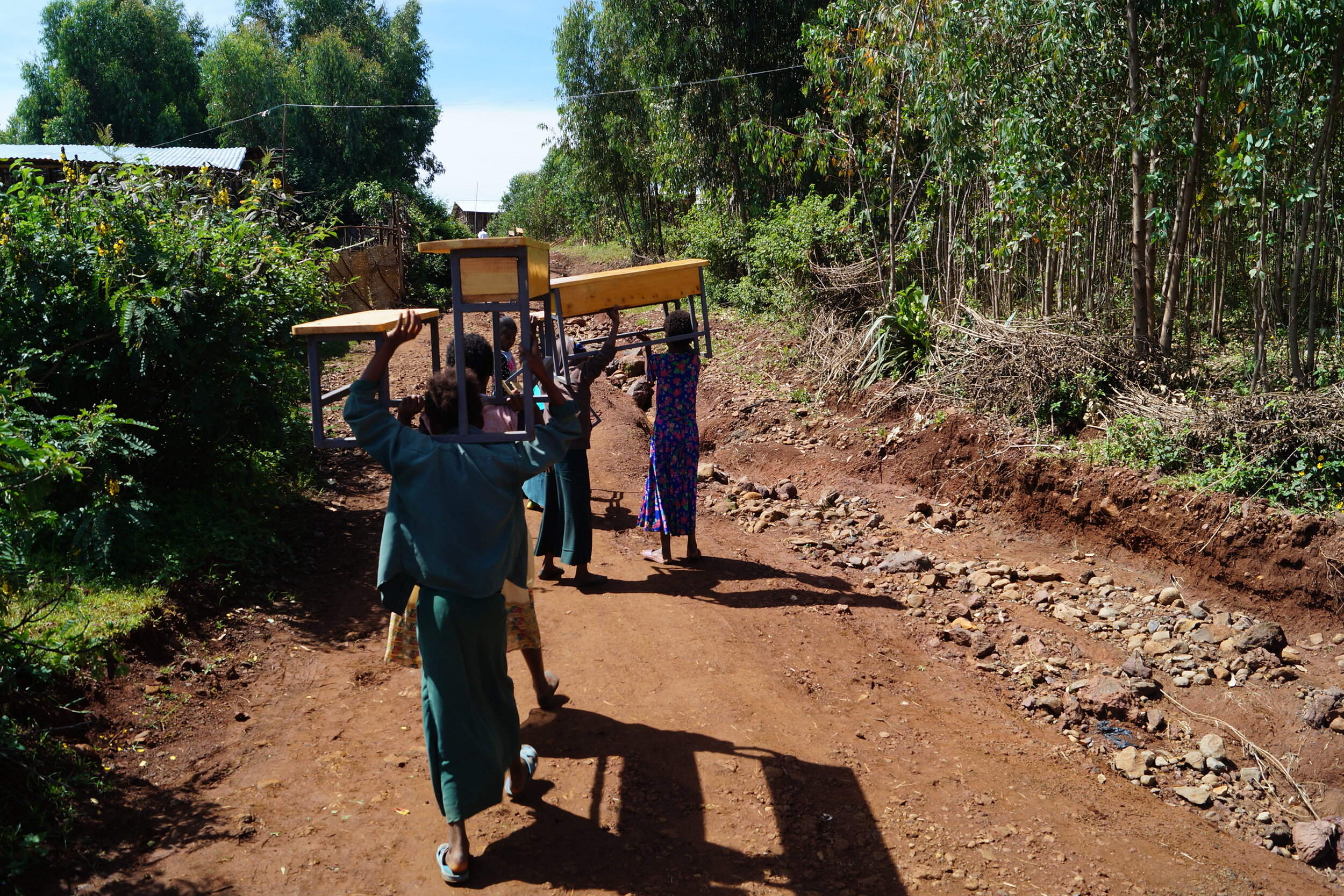 Students Carrying Desks to the New School
