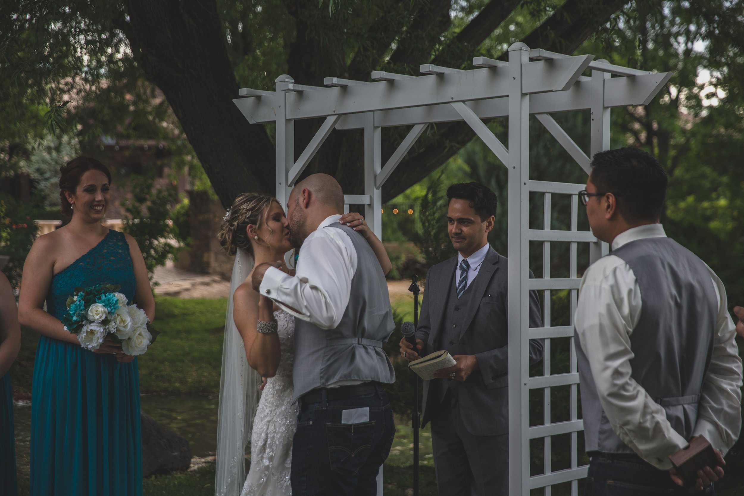  Bride and Groom share first kiss at Arizona wedding by Northern Arizona Wedding Photographer, Jennifer Lind Schutsky.  