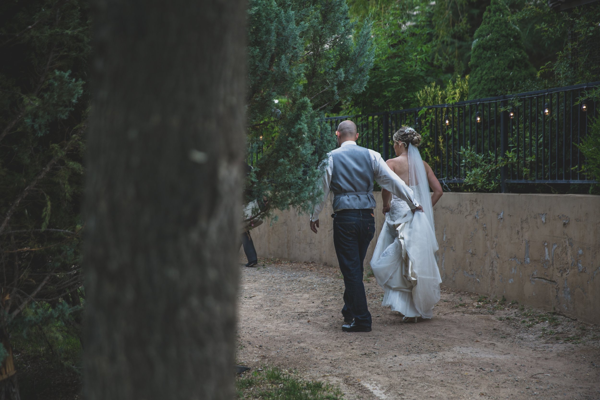  Bride and Groom walking at Arizona wedding by Northern Arizona Wedding Photographer, Jennifer Lind Schutsky.  