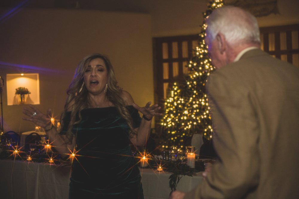  Guests dance at Christmas theme wedding reception at Grayhawk Golf Club by Scottsdale Wedding Photographer Jennifer Lind Schutsky. 