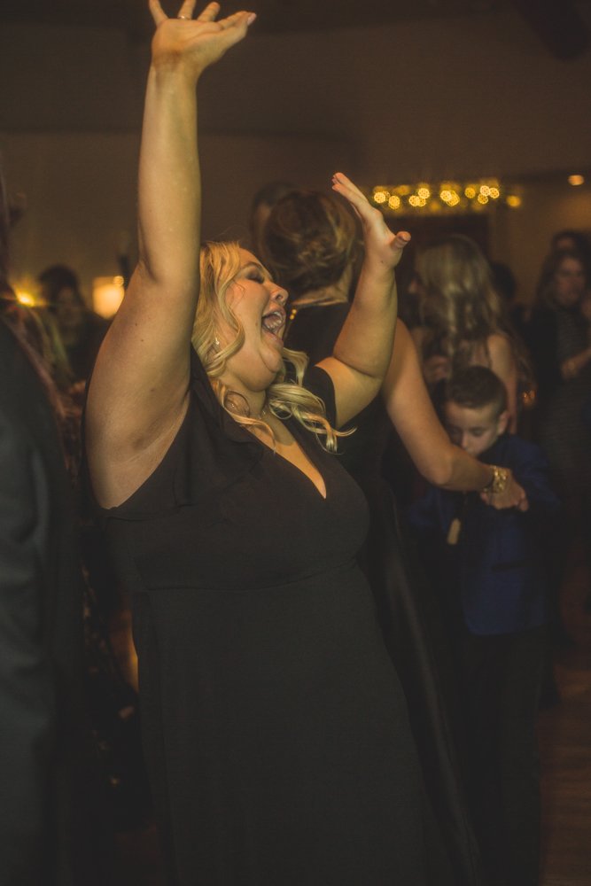  Guests dance at Christmas theme wedding reception at Grayhawk Golf Club by Scottsdale Wedding Photographer Jennifer Lind Schutsky. 