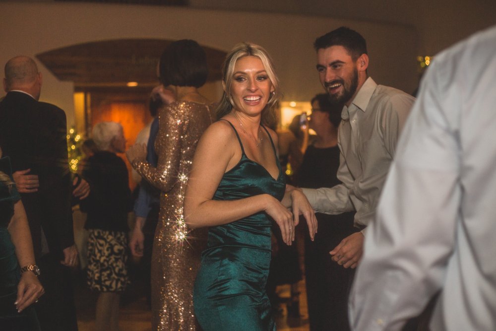  Guests dance at Christmas theme wedding reception at Grayhawk Golf Club by Scottsdale Wedding Photographer Jennifer Lind Schutsky. 