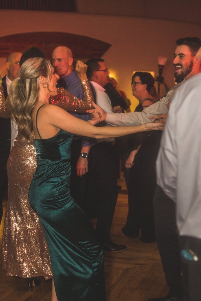  Guests celebrate at Christmas theme wedding reception at Grayhawk Golf Club by Scottsdale Wedding Photographer Jennifer Lind Schutsky. 