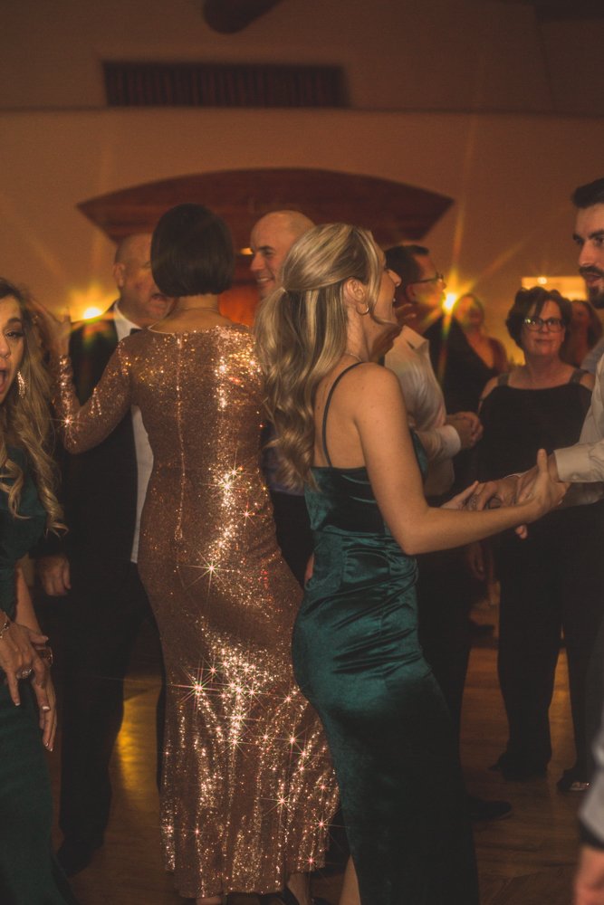  Guests celebrate at Christmas theme wedding reception at Grayhawk Golf Club by Scottsdale Wedding Photographer Jennifer Lind Schutsky. 