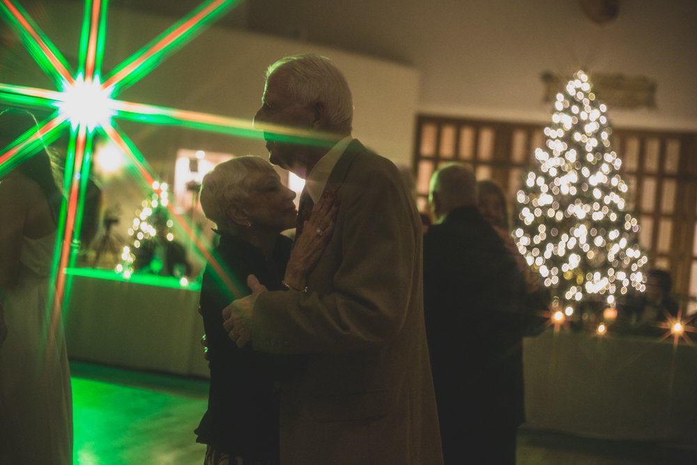  Guests celebrate at Christmas theme wedding reception at Grayhawk Golf Club by Scottsdale Wedding Photographer Jennifer Lind Schutsky. 