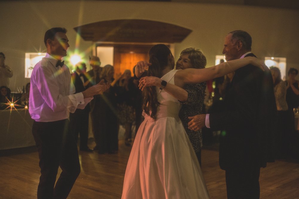  Bride and groom celebrate with guests at Christmas theme wedding reception at Grayhawk Golf Club by Scottsdale Wedding Photographer Jennifer Lind Schutsky. 