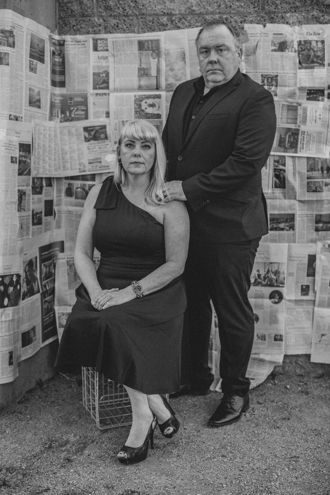 Family poses in front of handcrafter newspaper backdrop for creative session with creative phoenix photographer; Jennifer Lind Schutsky. 