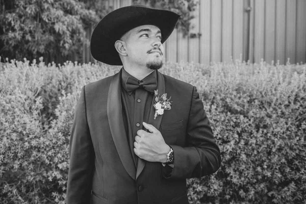  Groom’s  Mexican Cowboy / Vaquero Farm Portrait  at the Big Red Barn wedding at Schnepf Farms in Queen Creek, Arizona by Arizona based Photographer, Jennifer Lind Schutsky. 