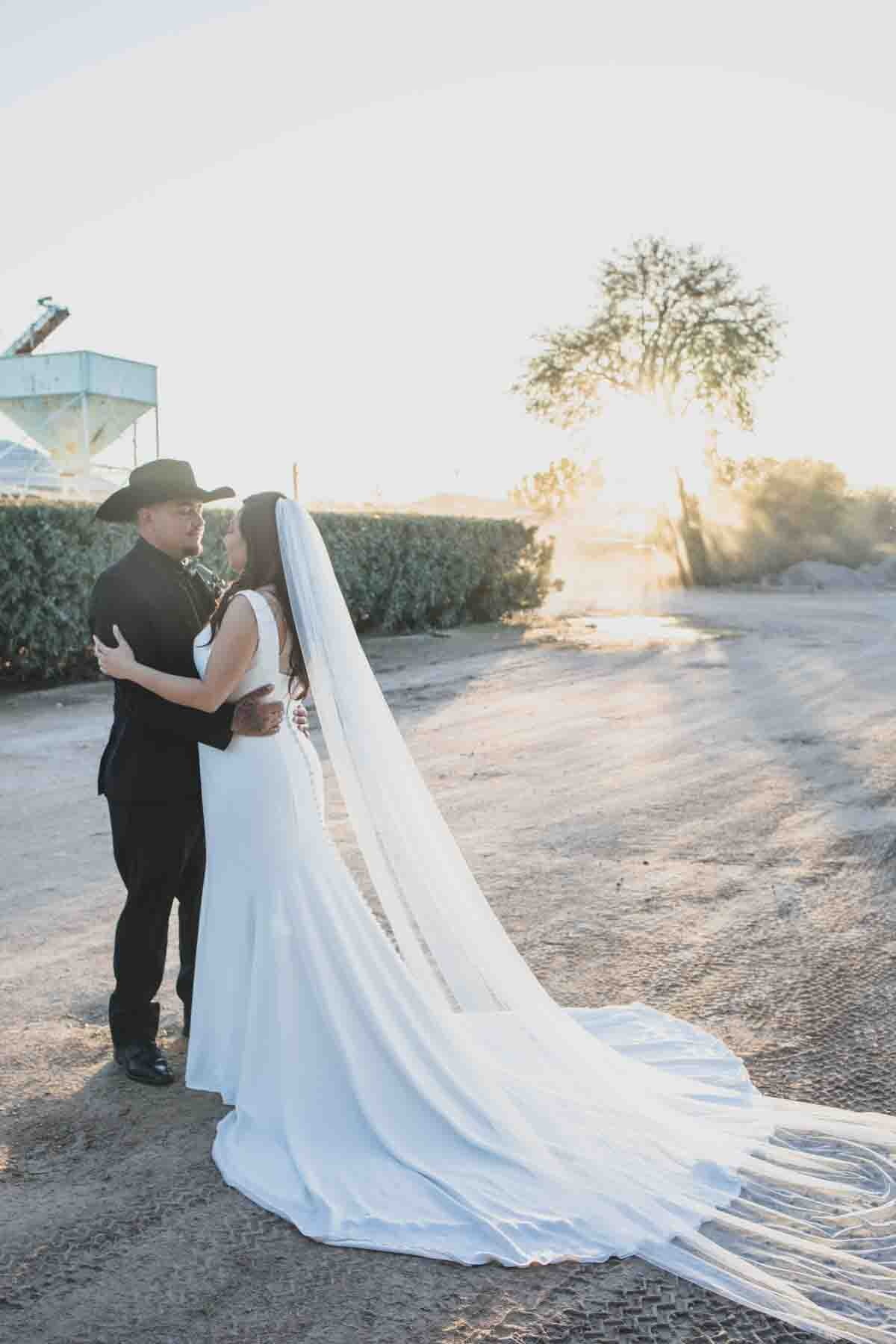  Bride and Groom at Mexican Cowboy / Vaquero Farm Wedding at the Big Red Barn wedding at Schnepf Farms in Queen Creek, Arizona by Arizona based Photographer, Jennifer Lind Schutsky. 