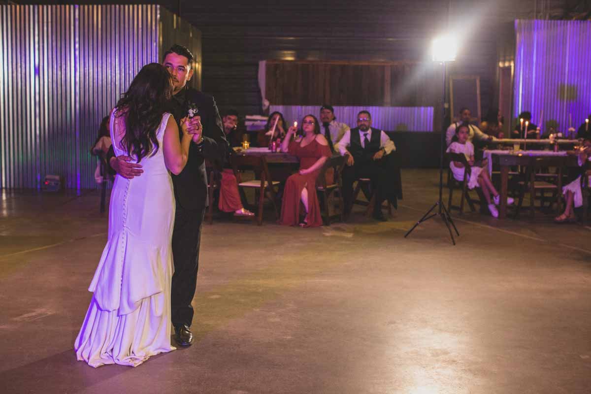  Newlyweds dance at their Wedding Reception Celebration at Mexican Cowboy / Vaquero Farm Wedding at the Big Red Barn wedding at Schnepf Farms in Queen Creek, Arizona by Arizona based Photographer, Jennifer Lind Schutsky. 