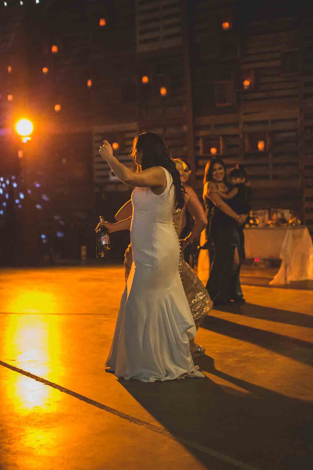  Newlyweds dance at their Wedding Reception Celebration at Mexican Cowboy / Vaquero Farm Wedding at the Big Red Barn wedding at Schnepf Farms in Queen Creek, Arizona by Arizona based Photographer, Jennifer Lind Schutsky. 