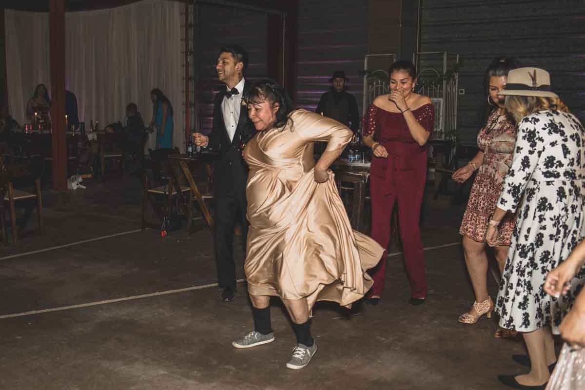  Guests dance at their Wedding Reception Celebration at Mexican Cowboy / Vaquero Farm Wedding at the Big Red Barn wedding at Schnepf Farms in Queen Creek, Arizona by Arizona based Photographer, Jennifer Lind Schutsky. 