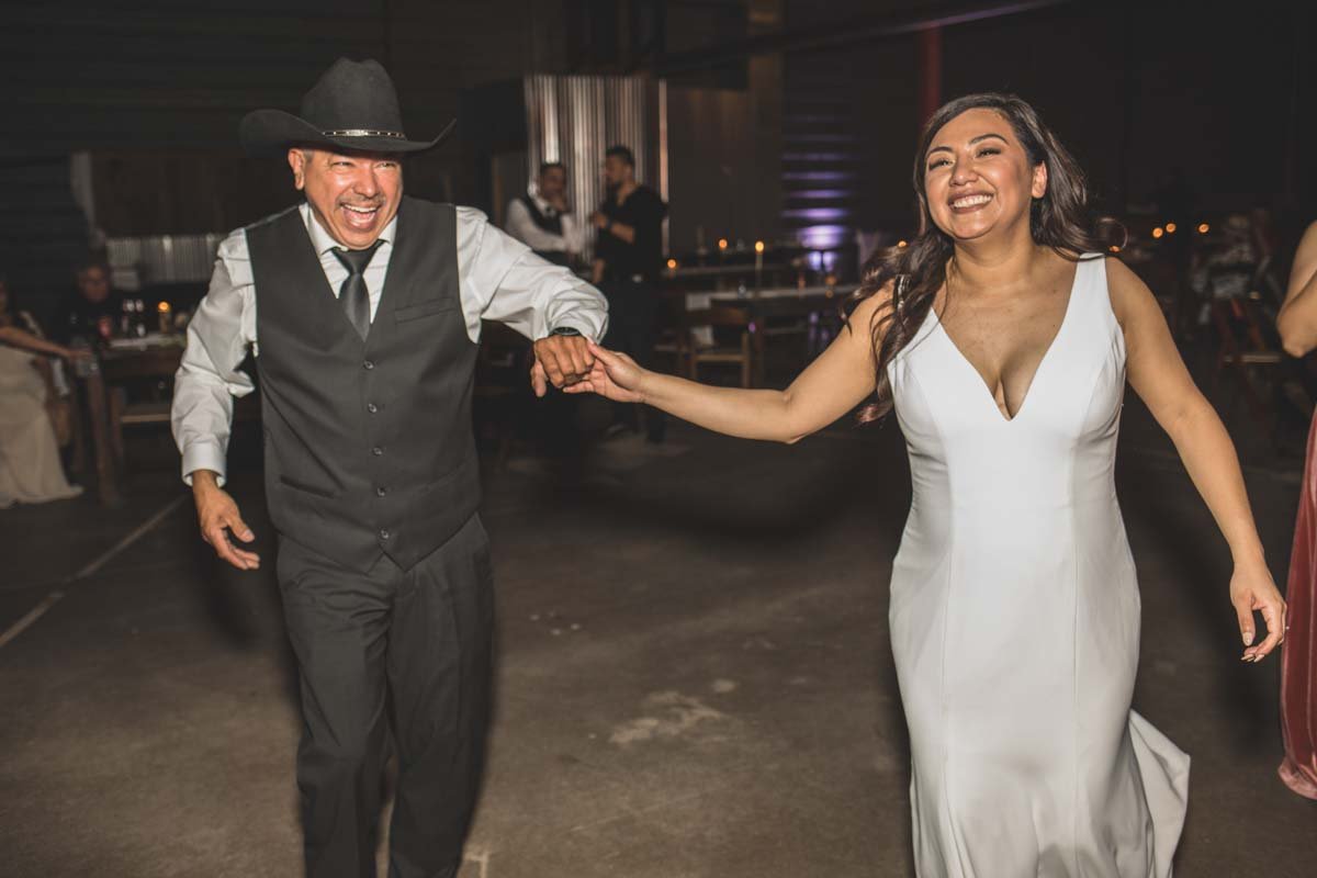  Bride and her guests dance at their Wedding Reception Celebration at Mexican Cowboy / Vaquero Farm Wedding at the Big Red Barn wedding at Schnepf Farms in Queen Creek, Arizona by Arizona based Photographer, Jennifer Lind Schutsky. 