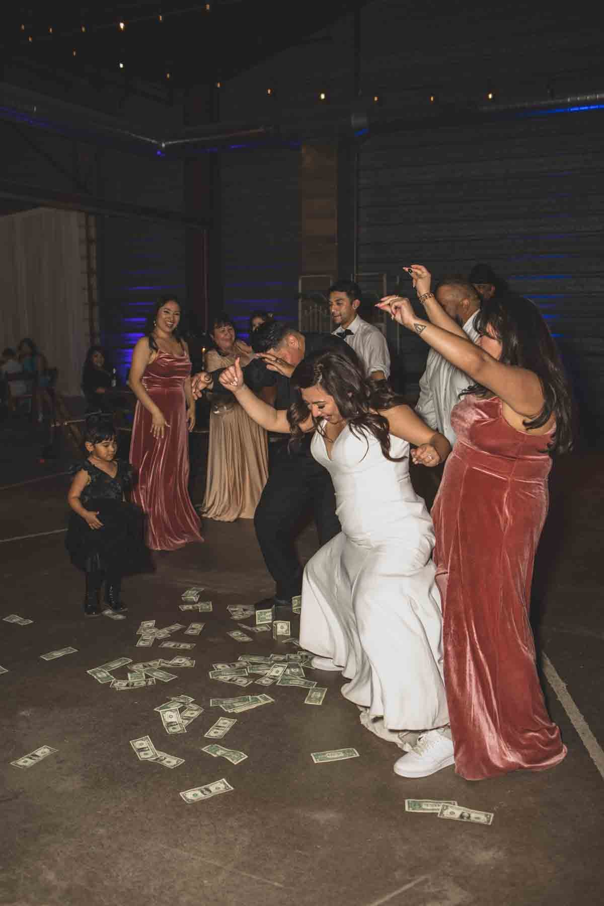 Bride and her guests dance at their Wedding Reception Celebration at Mexican Cowboy / Vaquero Farm Wedding at the Big Red Barn wedding at Schnepf Farms in Queen Creek, Arizona by Arizona based Photographer, Jennifer Lind Schutsky. 
