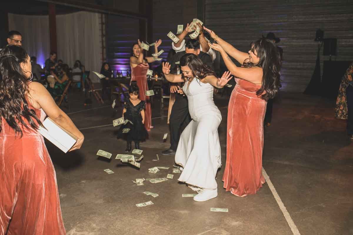  Bride and her guests dance at their Wedding Reception Celebration at Mexican Cowboy / Vaquero Farm Wedding at the Big Red Barn wedding at Schnepf Farms in Queen Creek, Arizona by Destination Wedding Photographer, Jennifer Lind Schutsky. 