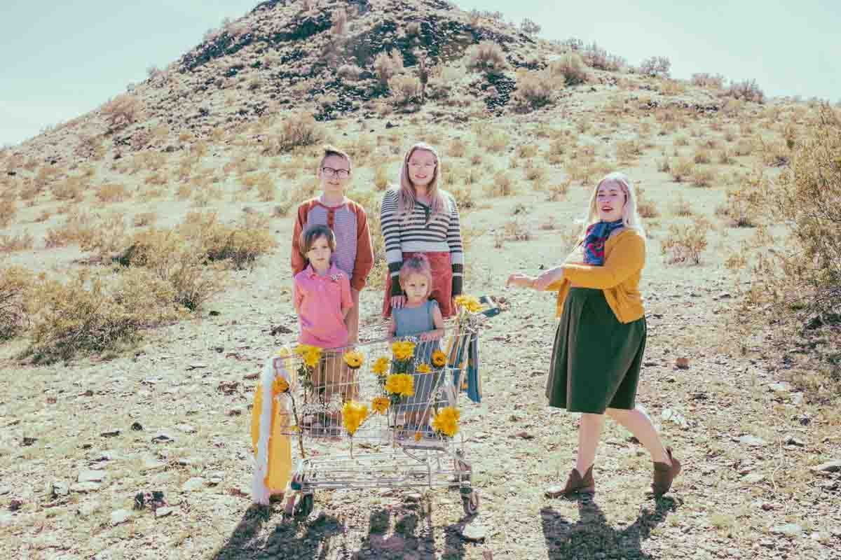  Family posing ideas; Mom pushing grocery cart in the desert during Creative Photography Family Session with best Phoenix family photographer, Jennifer Lind Schutsky. 