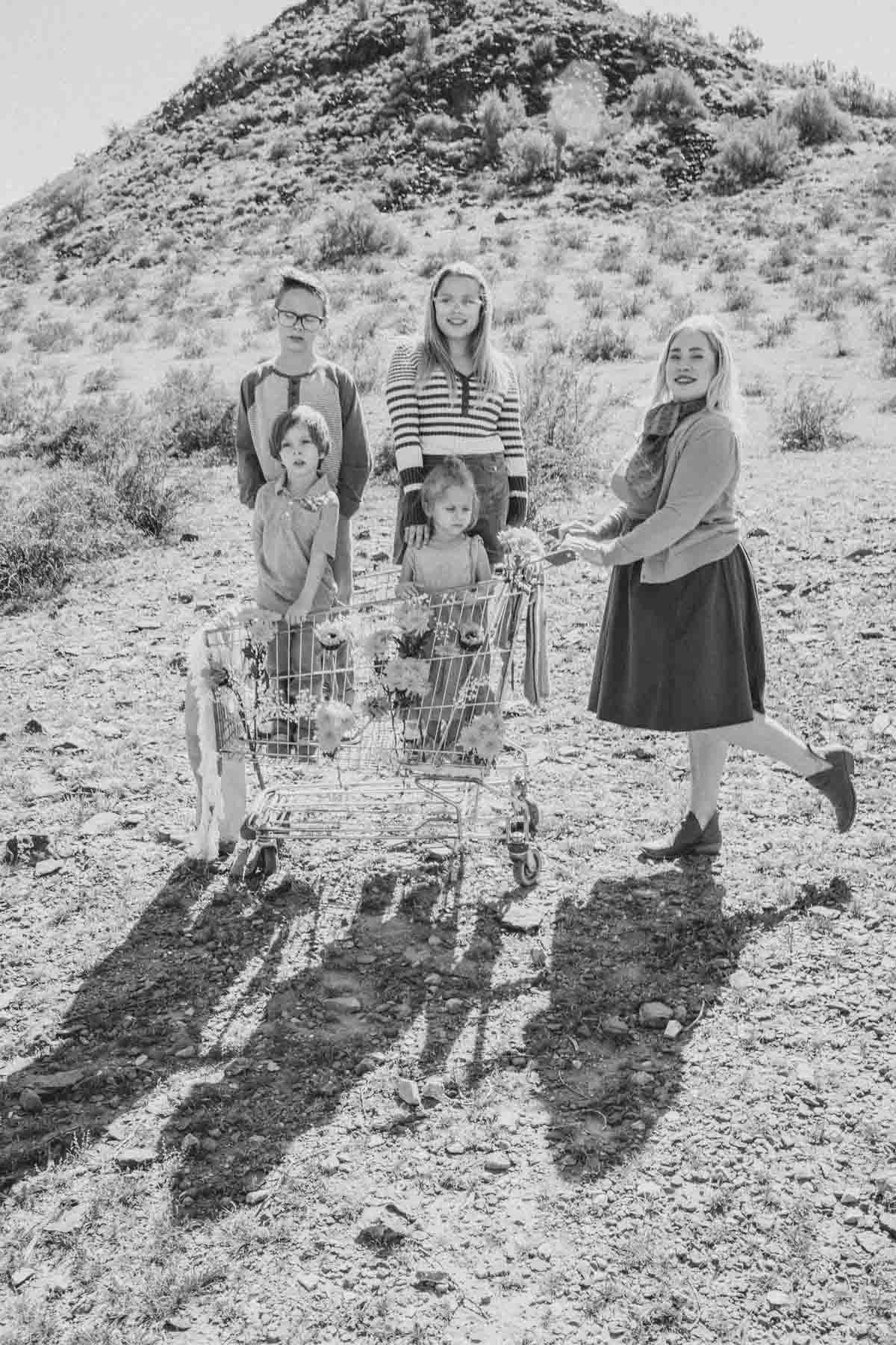  Family posing ideas; Mom pushing grocery cart in the desert during Creative Photography Family Session with best Phoenix family photographer, Jennifer Lind Schutsky. 