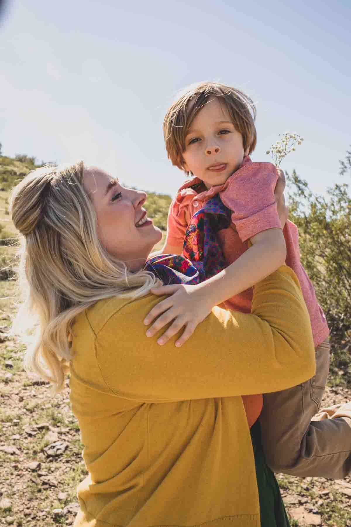  Family posing ideas; Mom picking up son in the desert during Creative Photography Family Session with best Phoenix family photographer, Jennifer Lind Schutsky. 