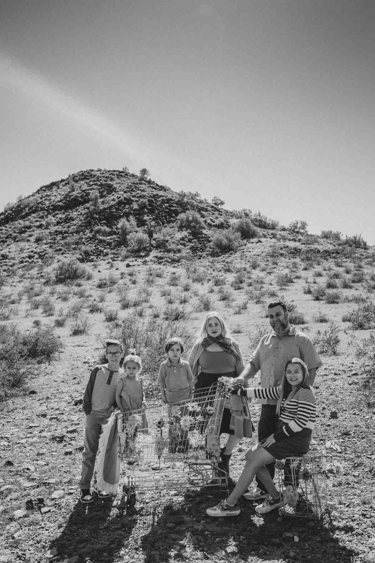  Family posing together in a shopping cart during Creative Photography Family Session with best Phoenix family photographer, Jennifer Lind Schutsky. 