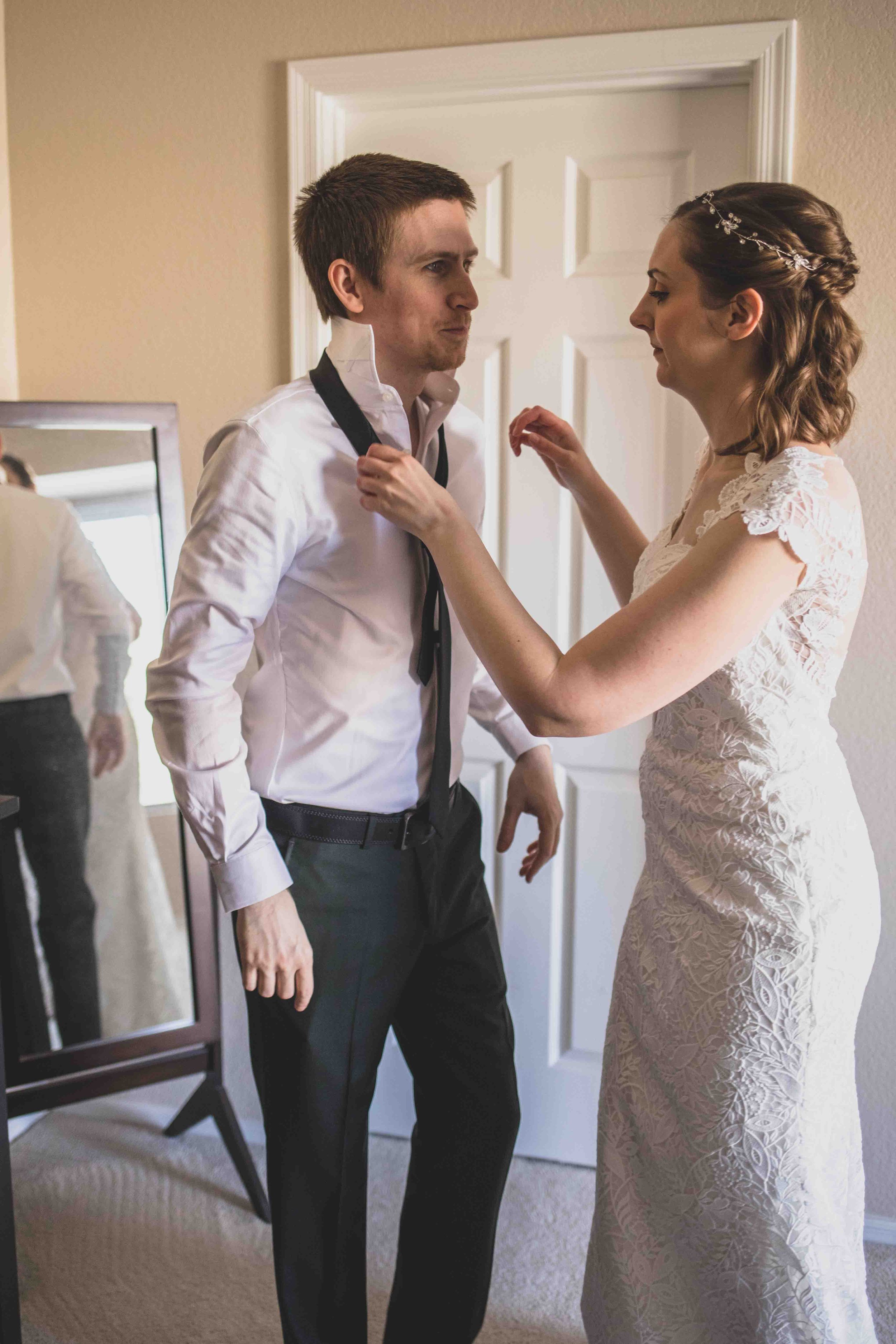 Bride and Groom getting ready together for their wedding day at home by Gilbert Wedding Photographer Jennifer Lind Schutsky.