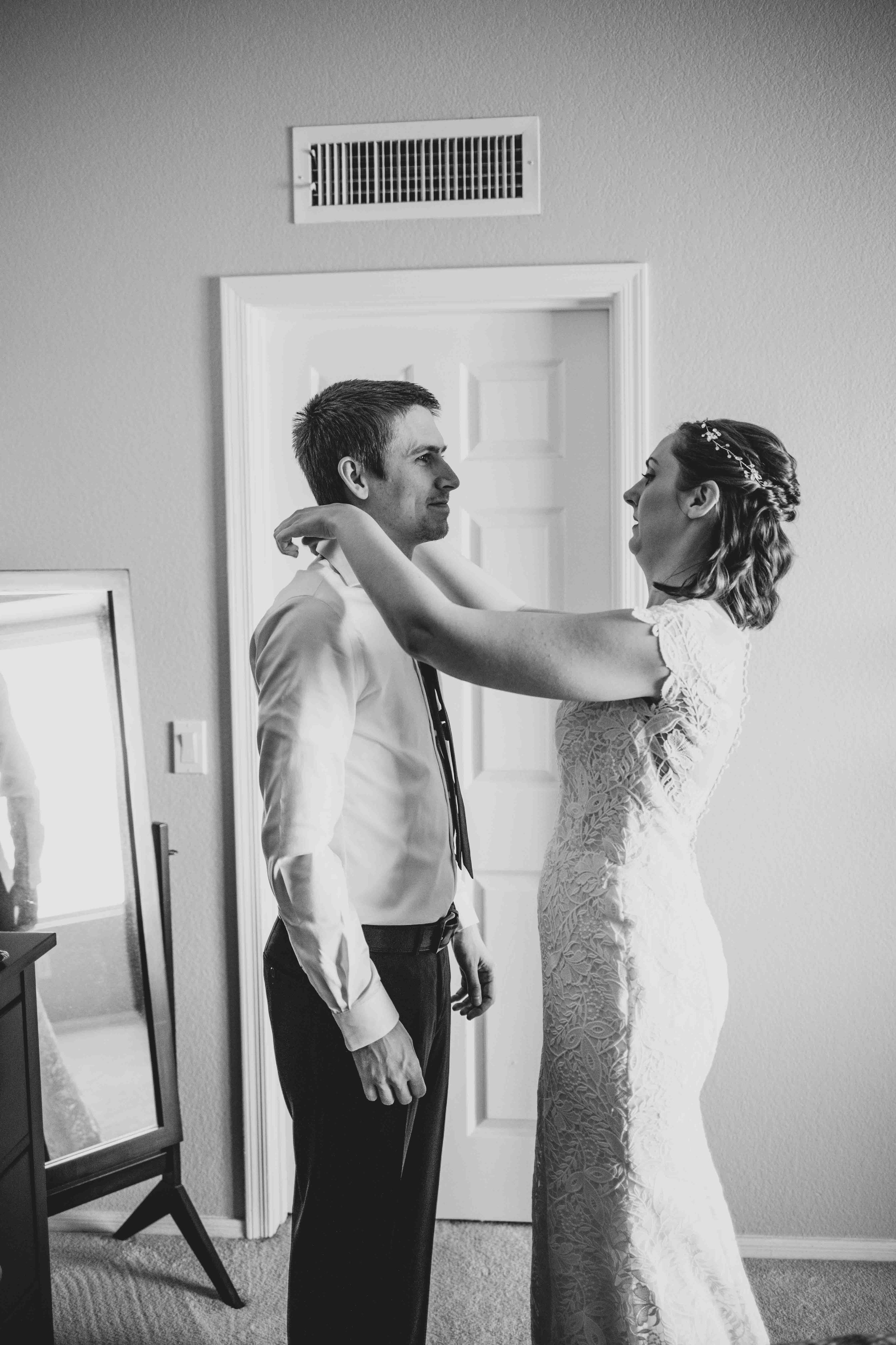 Bride and Groom getting ready together for their wedding day at home by Gilbert Wedding Photographer Jennifer Lind Schutsky.