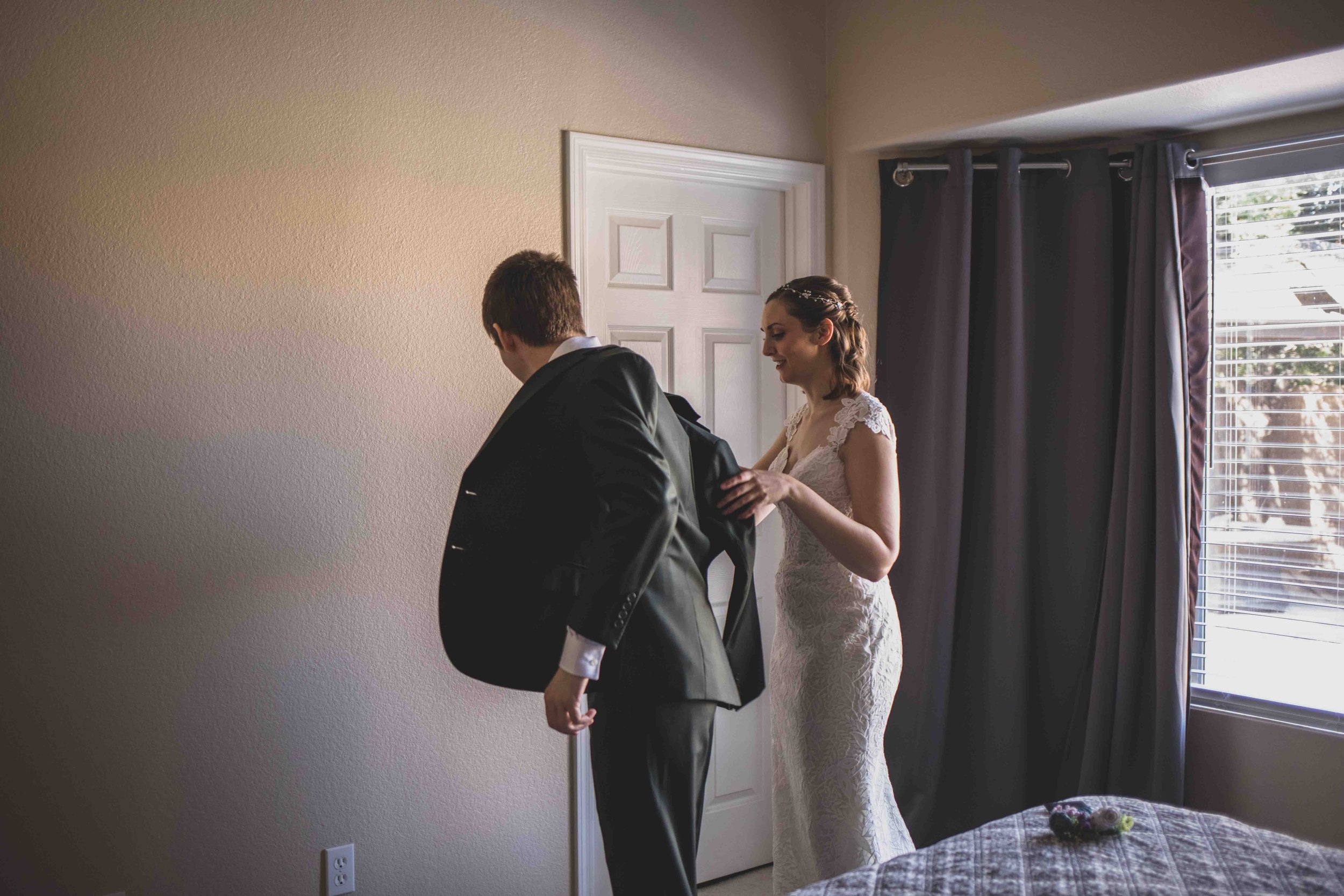 Bride and Groom getting ready together for their wedding day at home by Gilbert, Arizona Wedding Photographer Jennifer Lind Schutsky.