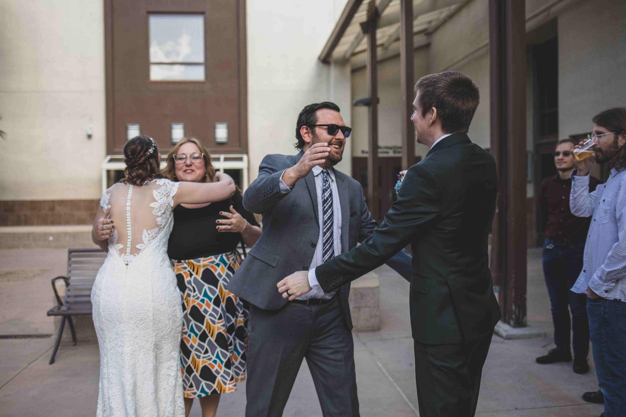 Bride and Groom greet guest at their wedding day by Gilbert, Arizona Wedding Photographer Jennifer Lind Schutsky.