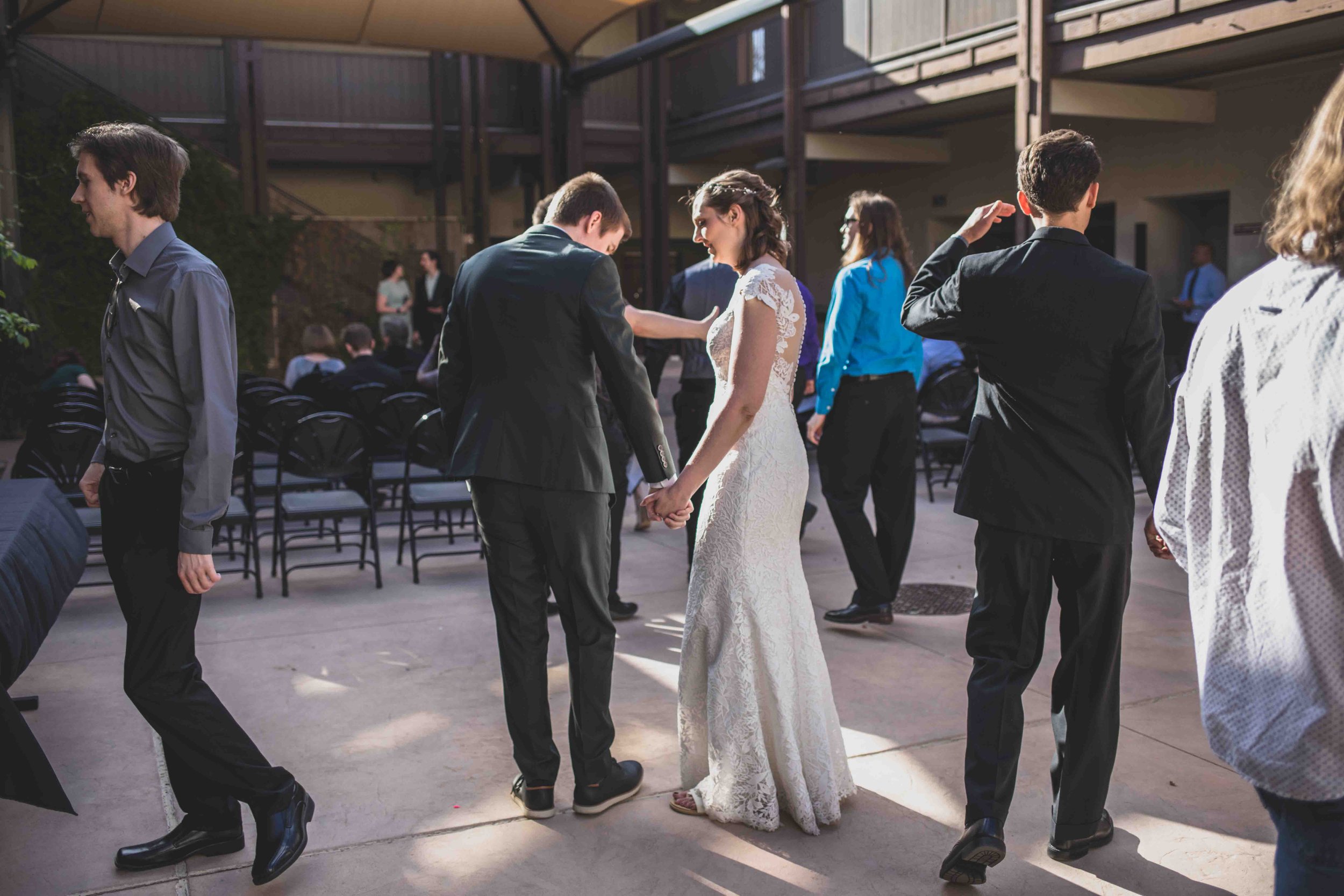 Bride and Groom greet guest at their wedding day by Gilbert, Arizona Wedding Photographer Jennifer Lind Schutsky.