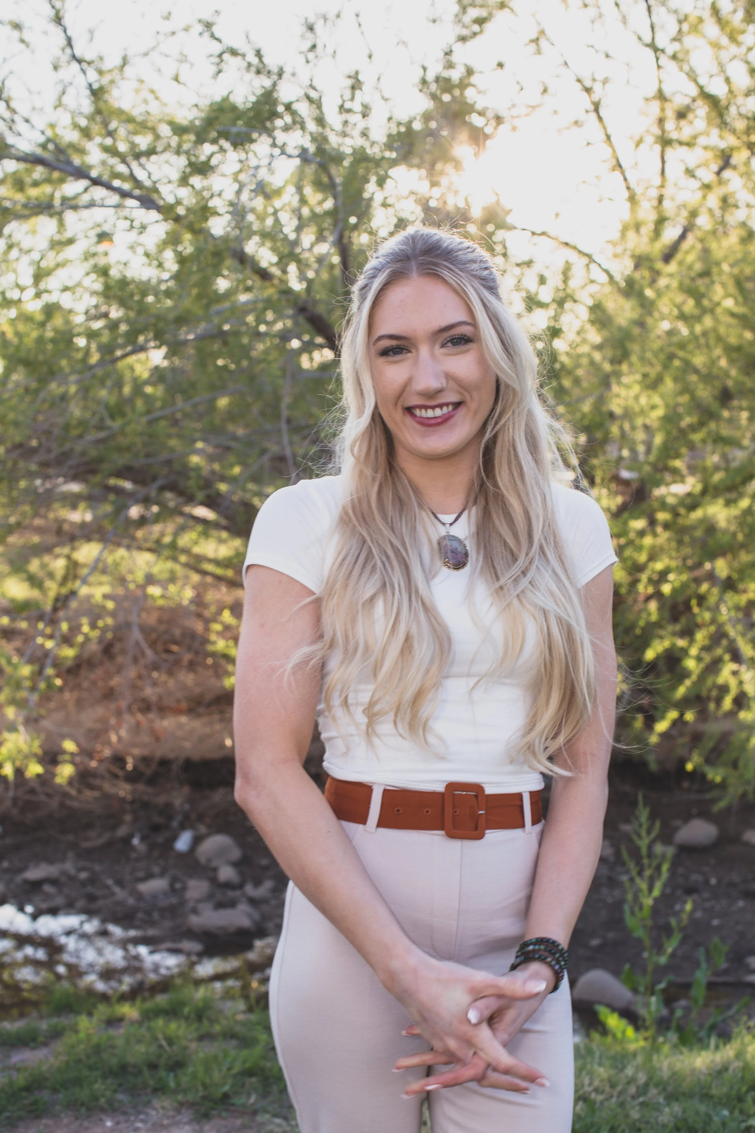  Woman poses in front of natural backdrop for professional headshots by Scottsdale based Corporate Branding Photographer, Jennifer Lind Schutsky in Arizona. 