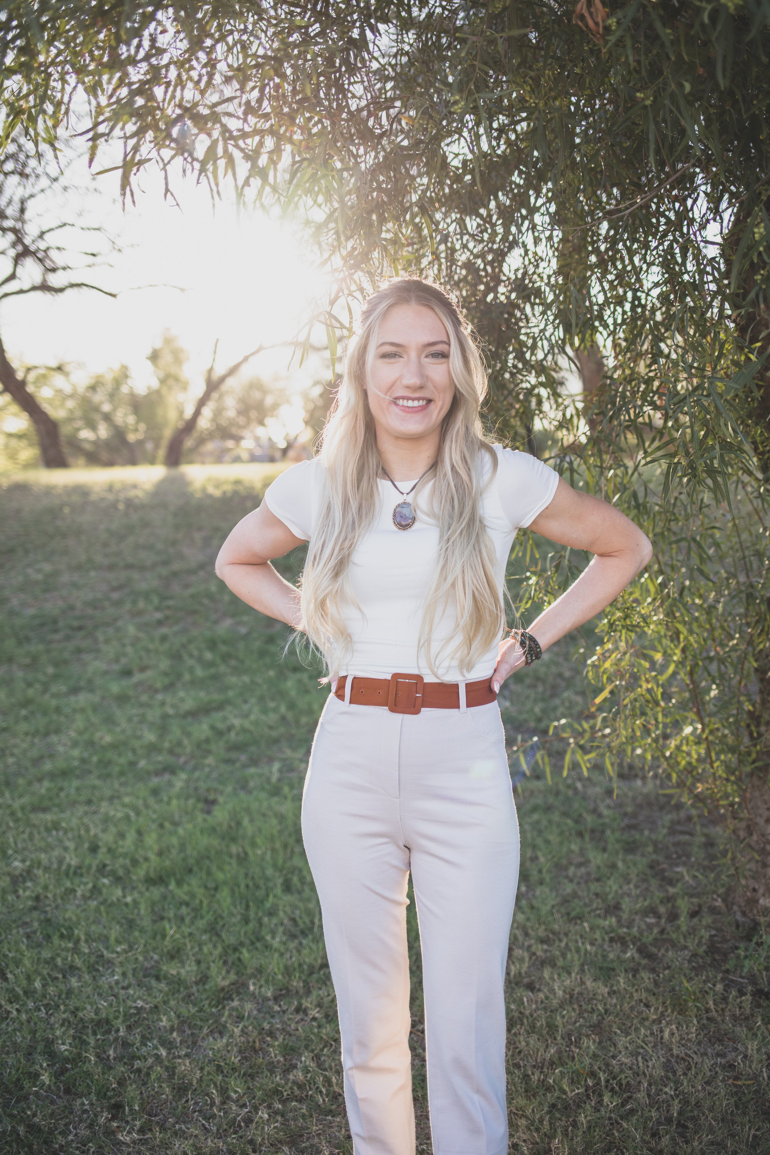 Woman poses in front of natural backdrop for professional headshots by Scottsdale based Corporate Branding Photographer, Jennifer Lind Schutsky in Arizona.