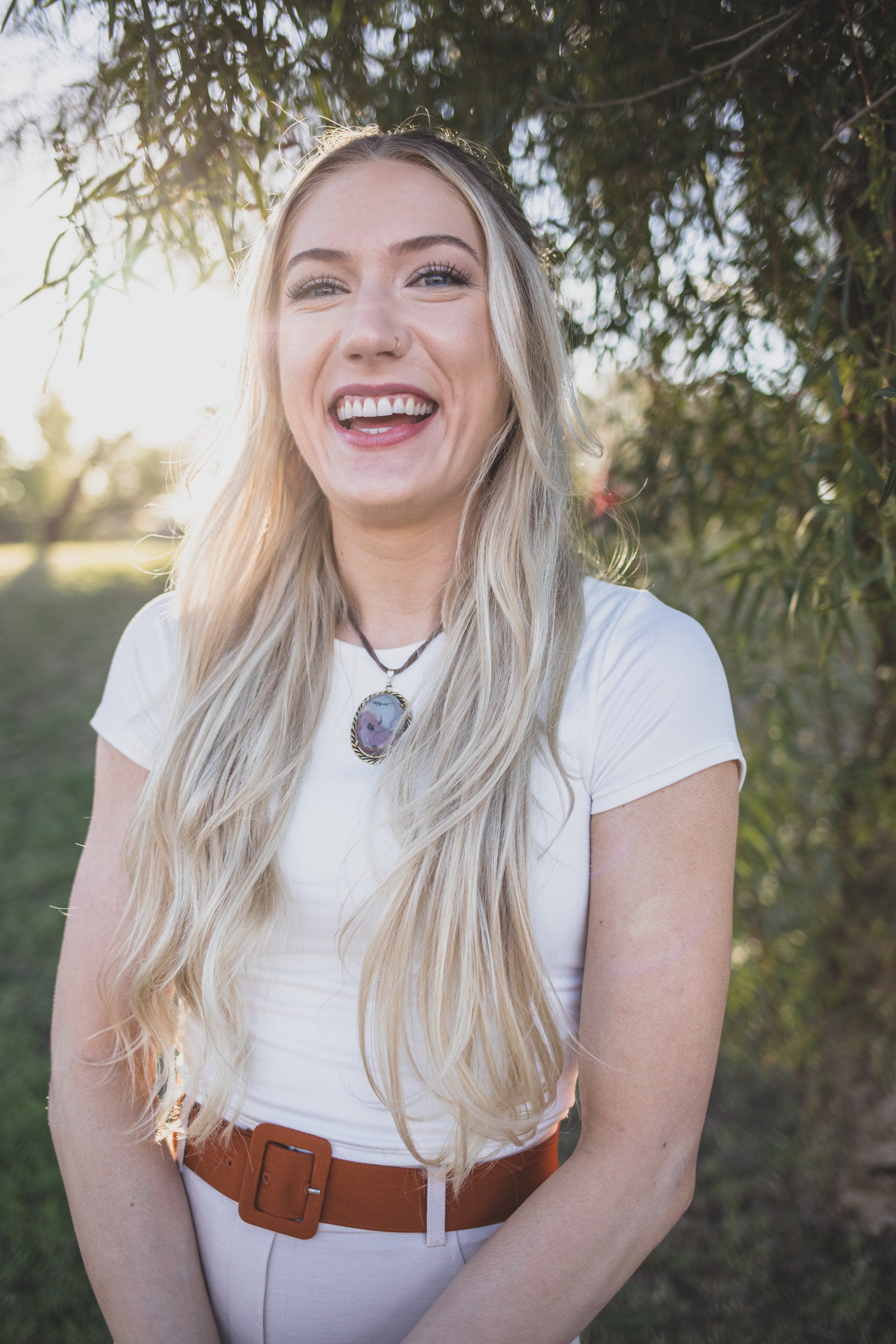 Woman Laughs in front of natural backdrop for professional headshots by Scottsdale based Corporate Branding Photographer, Jennifer Lind Schutsky in Arizona.