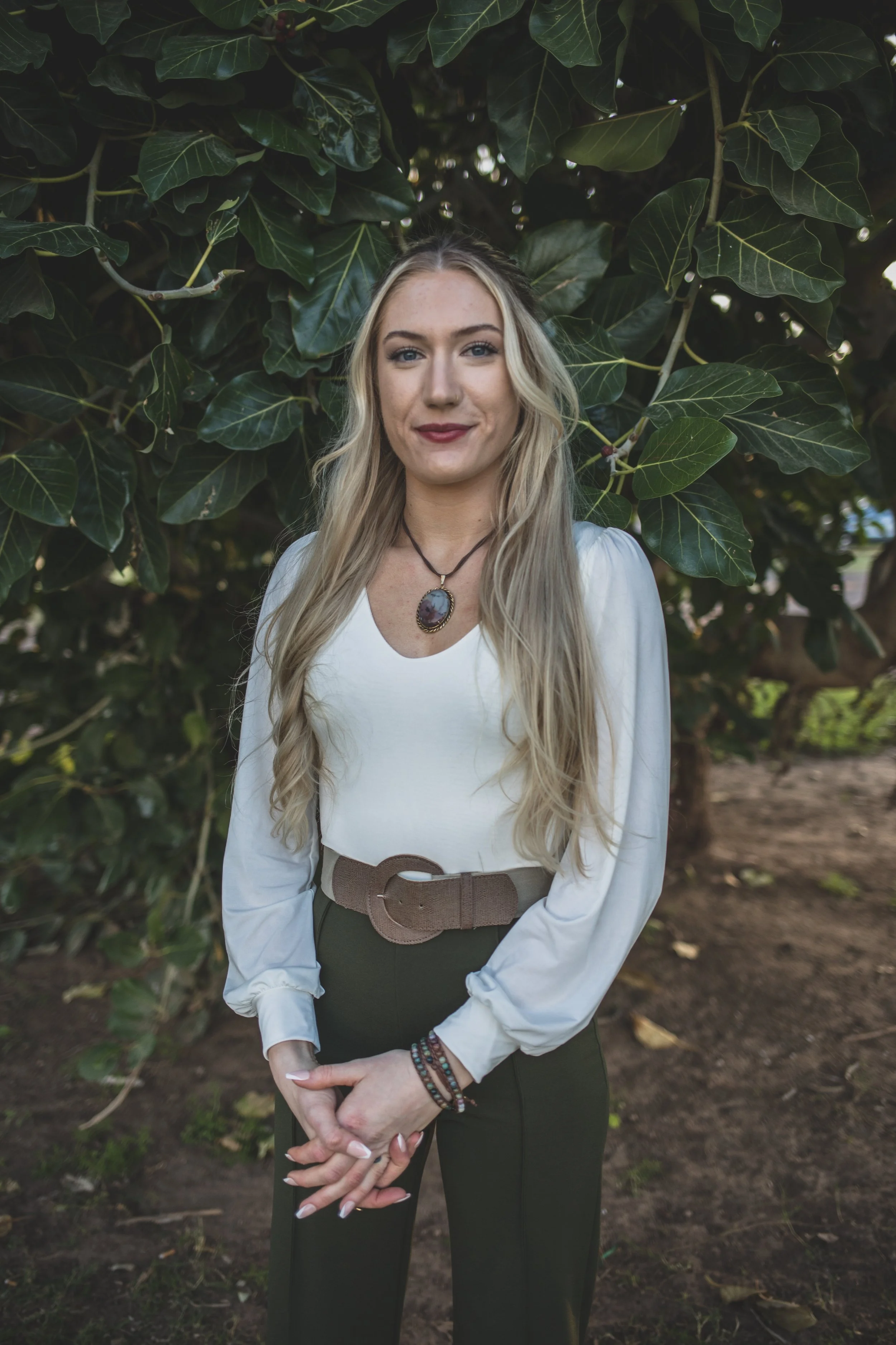 Woman poses in front of natural backdrop at Eldorado Park for professional headshots by Scottsdale based Corporate Branding Photographer, Jennifer Lind Schutsky in Scottsdale, Arizona.