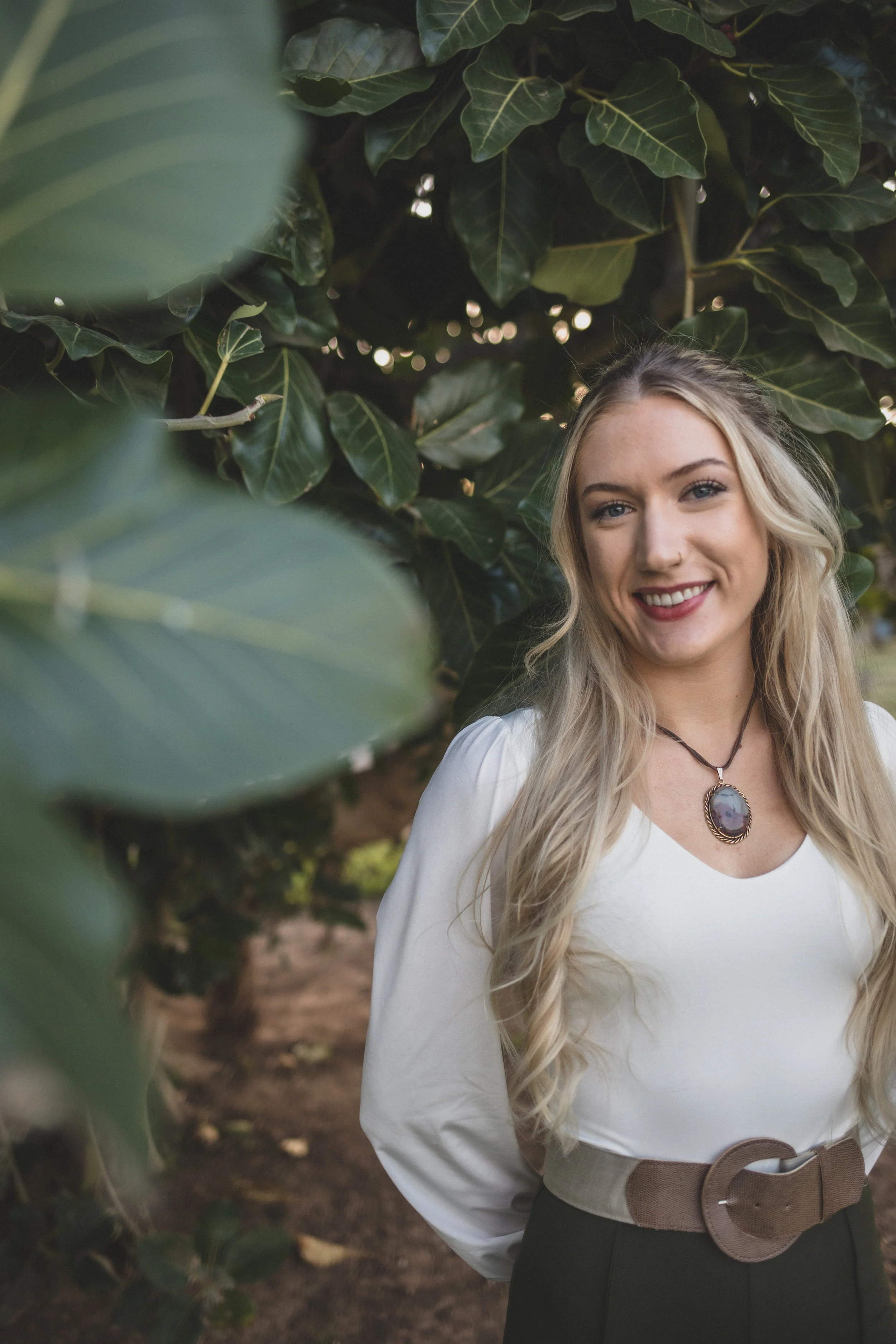 Woman poses in front of natural backdrop at Eldorado Park for professional headshots by Scottsdale based Corporate Branding Photographer, Jennifer Lind Schutsky in Scottsdale, Arizona.