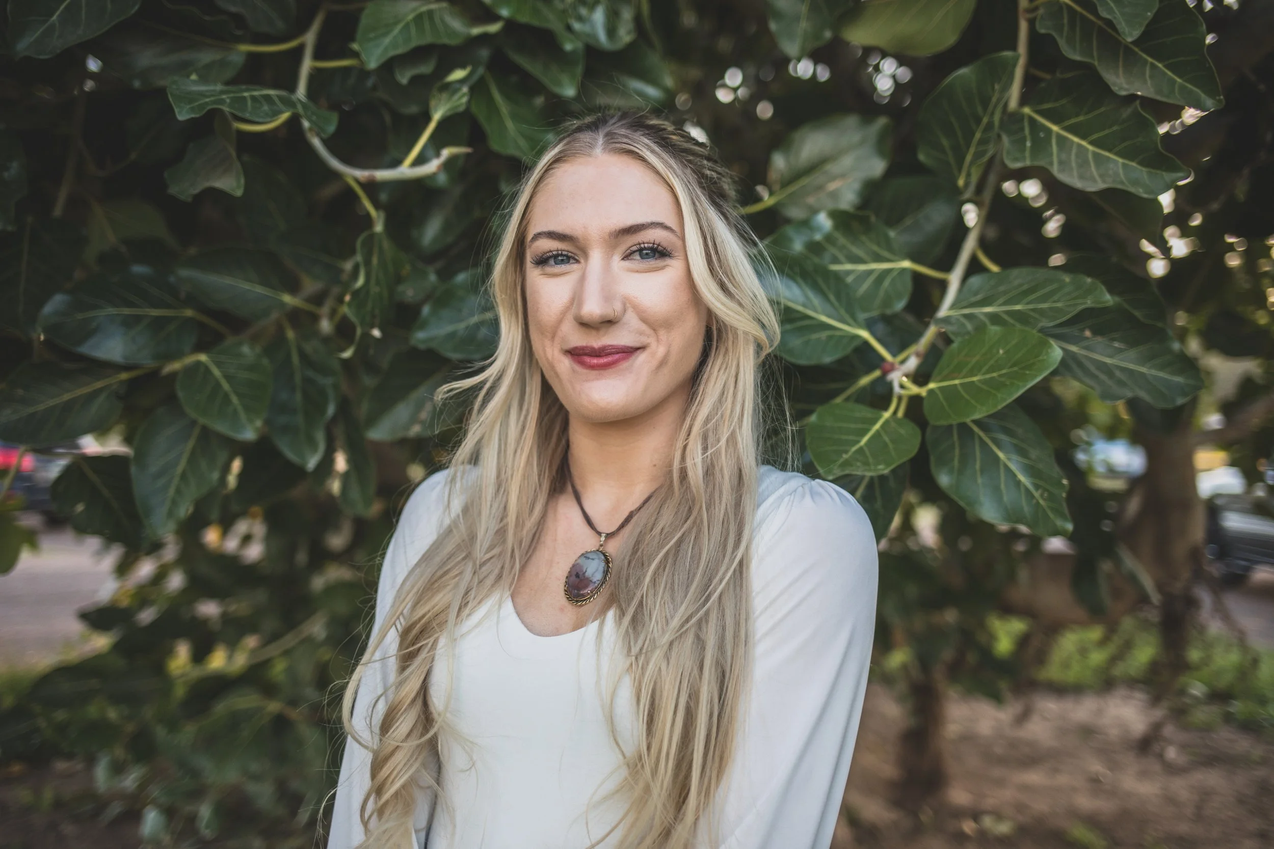 Woman poses in front of natural backdrop at Eldorado Park for professional headshots by Scottsdale based Corporate Branding Photographer, Jennifer Lind Schutsky in Scottsdale, Arizona.