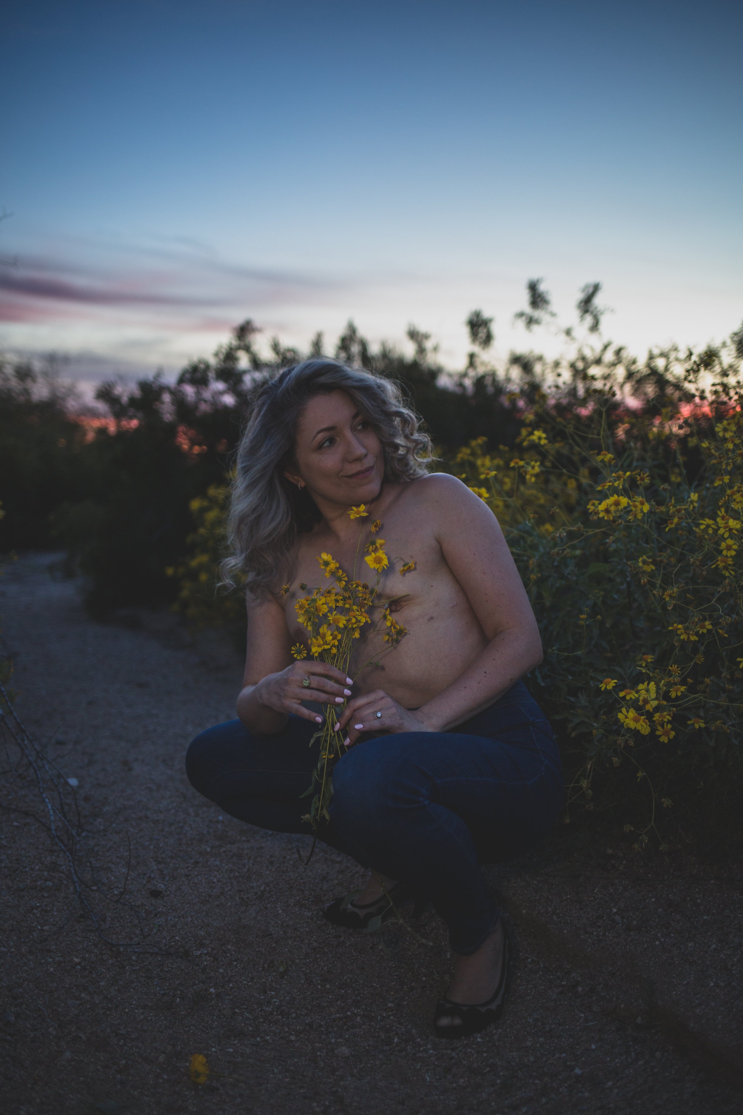 Breast Cancer survivor and thriver poses for wildflower desert boudoir session with Arizona creative boudoir photographer; Jennifer Lind Schutsky.