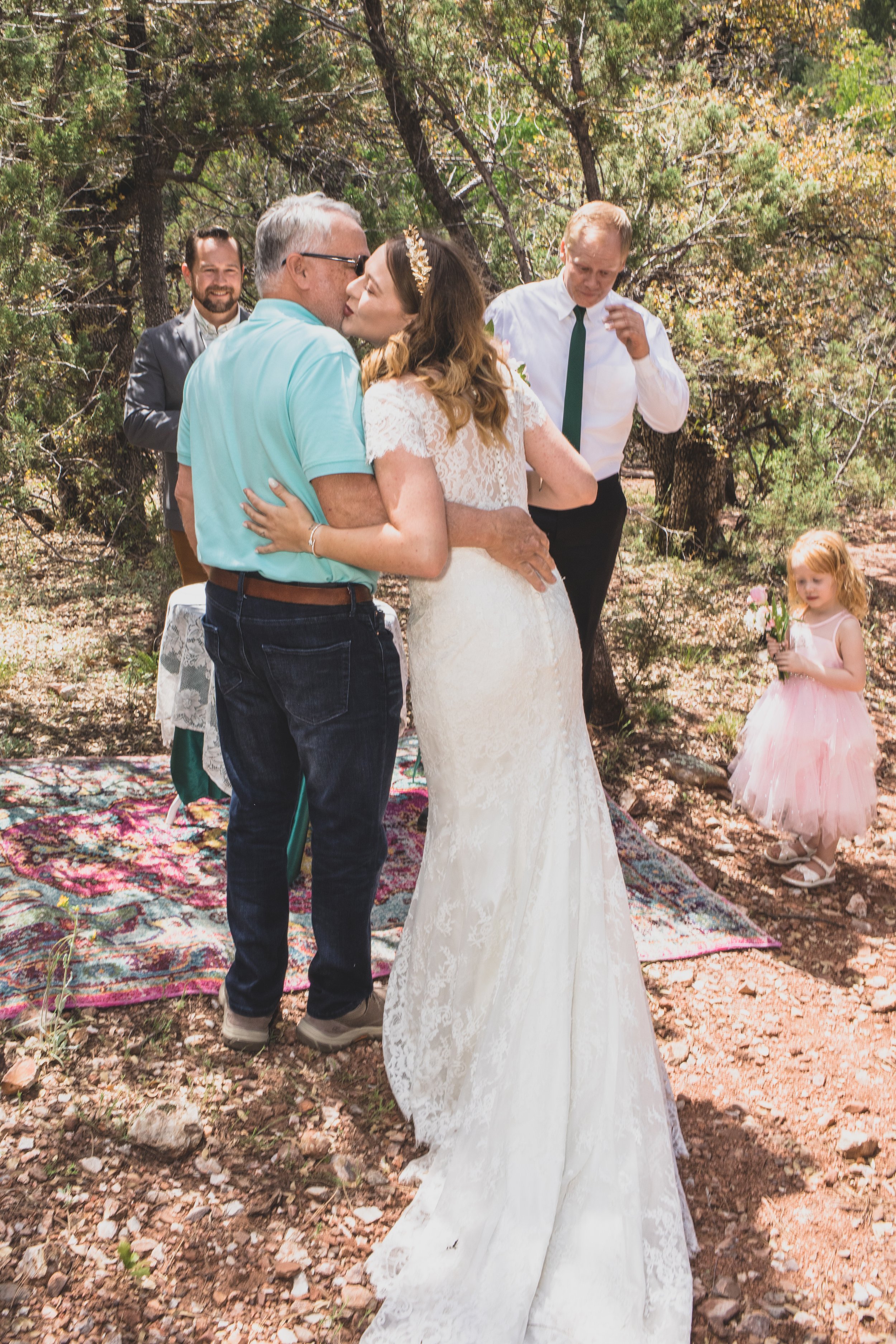 Groom looking at his Bride on their wedding day at their high noon desert elopement in Payson, Arizona by Arizona Elopement Photographer Jennifer Lind Schutsky.