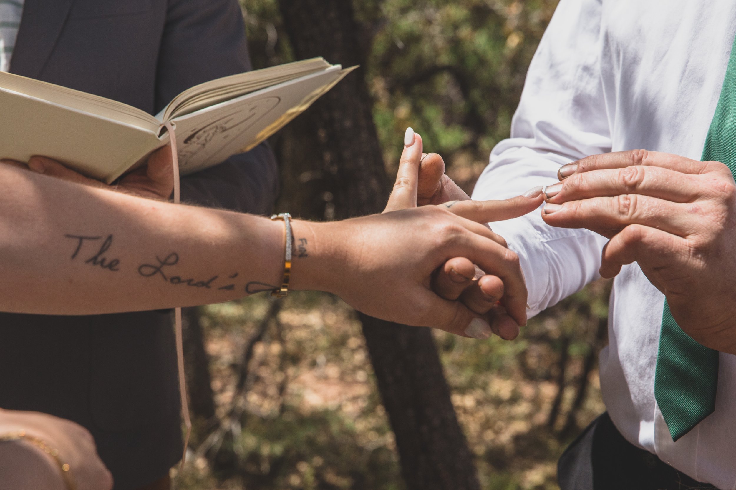 Couple exchanging rings on their wedding day at their high noon desert elopement in Payson, Arizona by Arizona Elopement Photographer Jennifer Lind Schutsky.