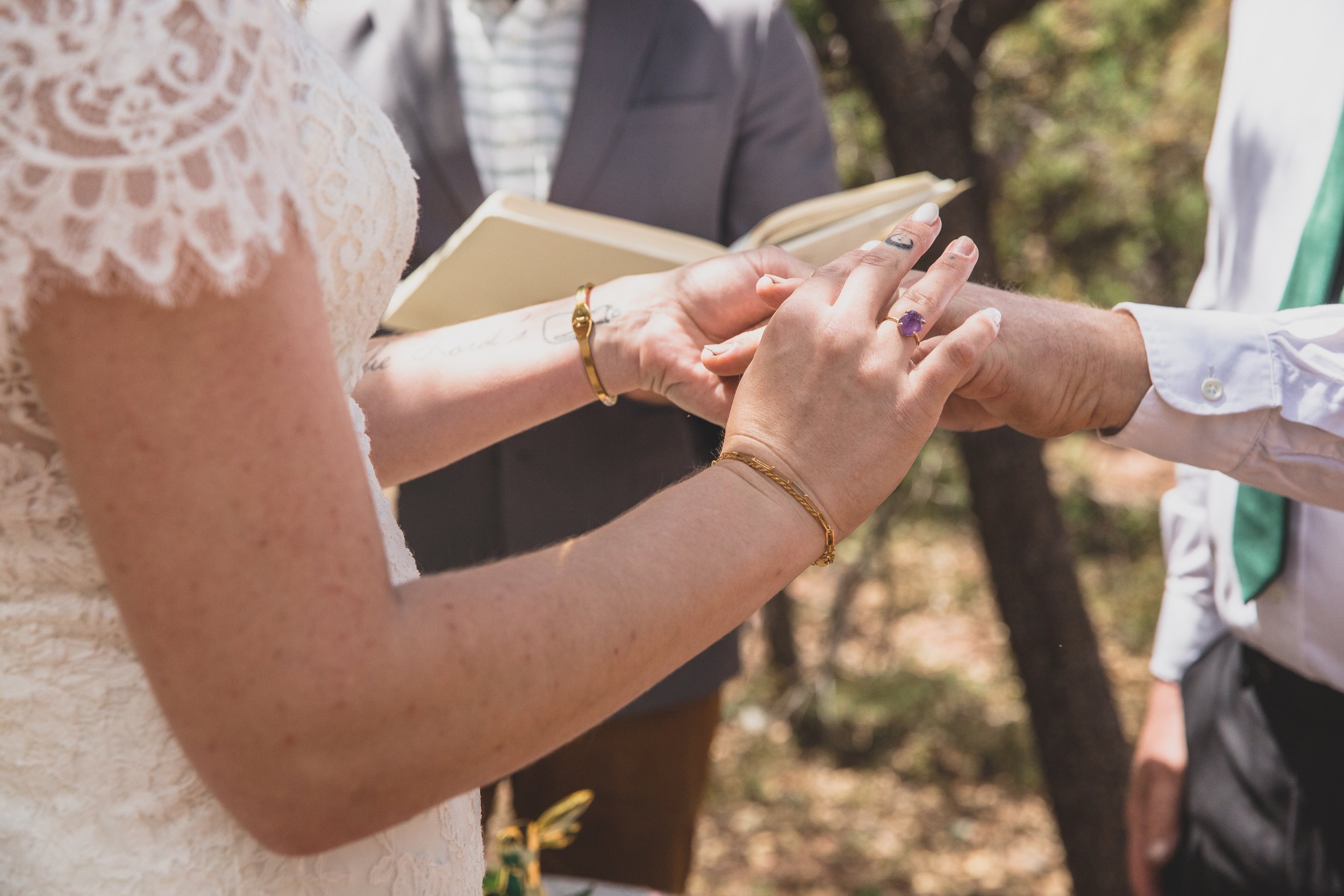 Couple exchanging rings on their wedding day at their high noon desert elopement in Payson, Arizona by Arizona Elopement Photographer Jennifer Lind Schutsky.