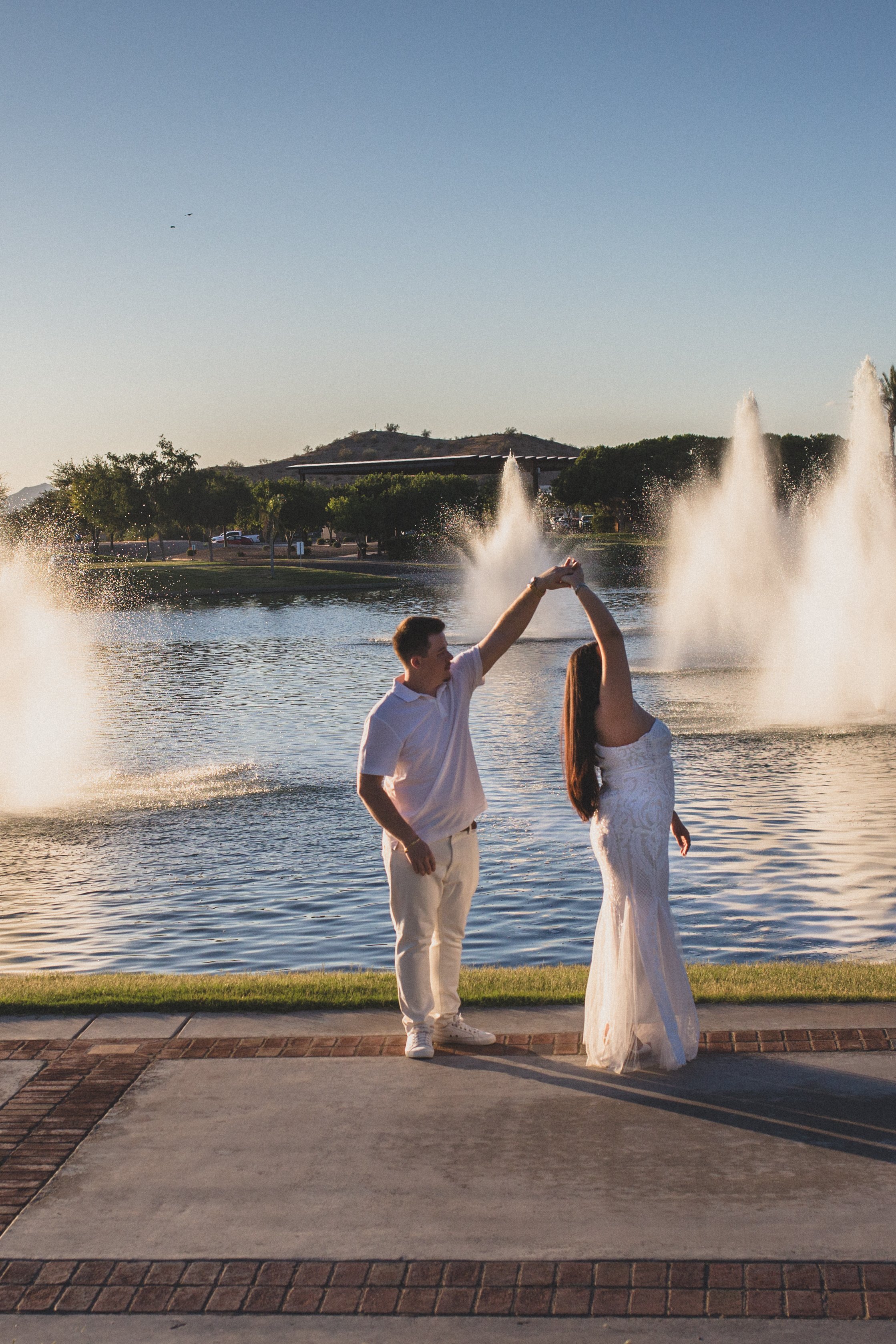 Couple Dances together for their Estrella Mountain Lakes engagement session in Phoenix, Arizona by epic Wedding Photographer; Jennifer Lind Schutsky.