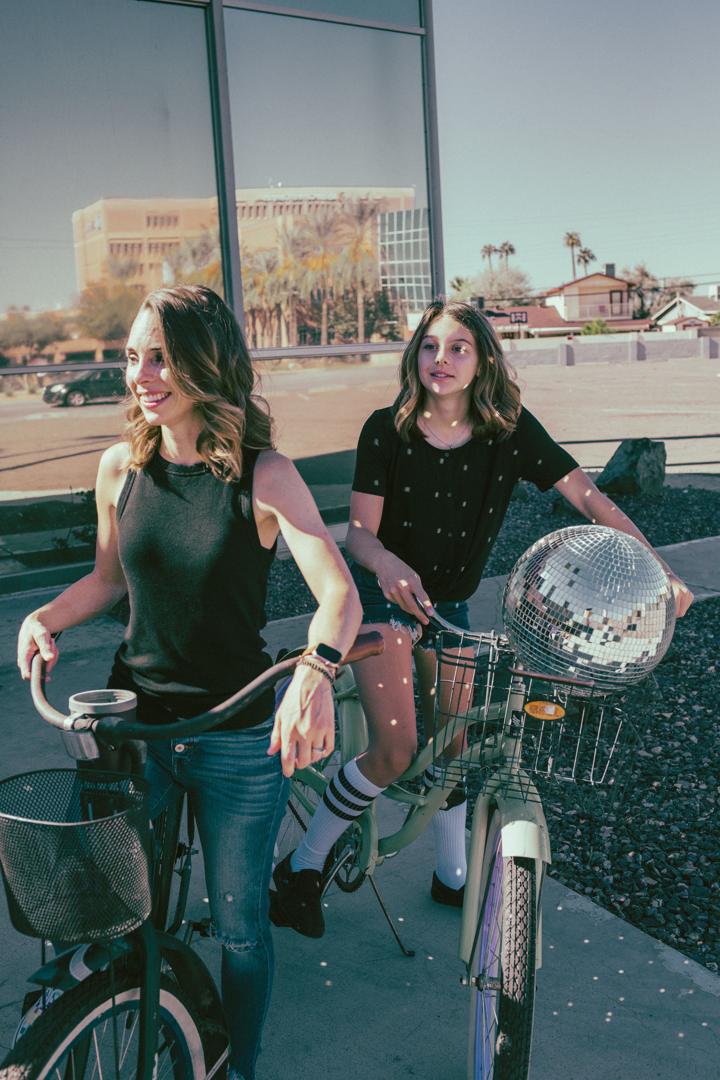 Family poses for their retro bike and skateboard photoshoot at Bowlero in Phoenix, Arizona by the most creative family photographer in Phoenix; Jennifer Lind Schutsky.