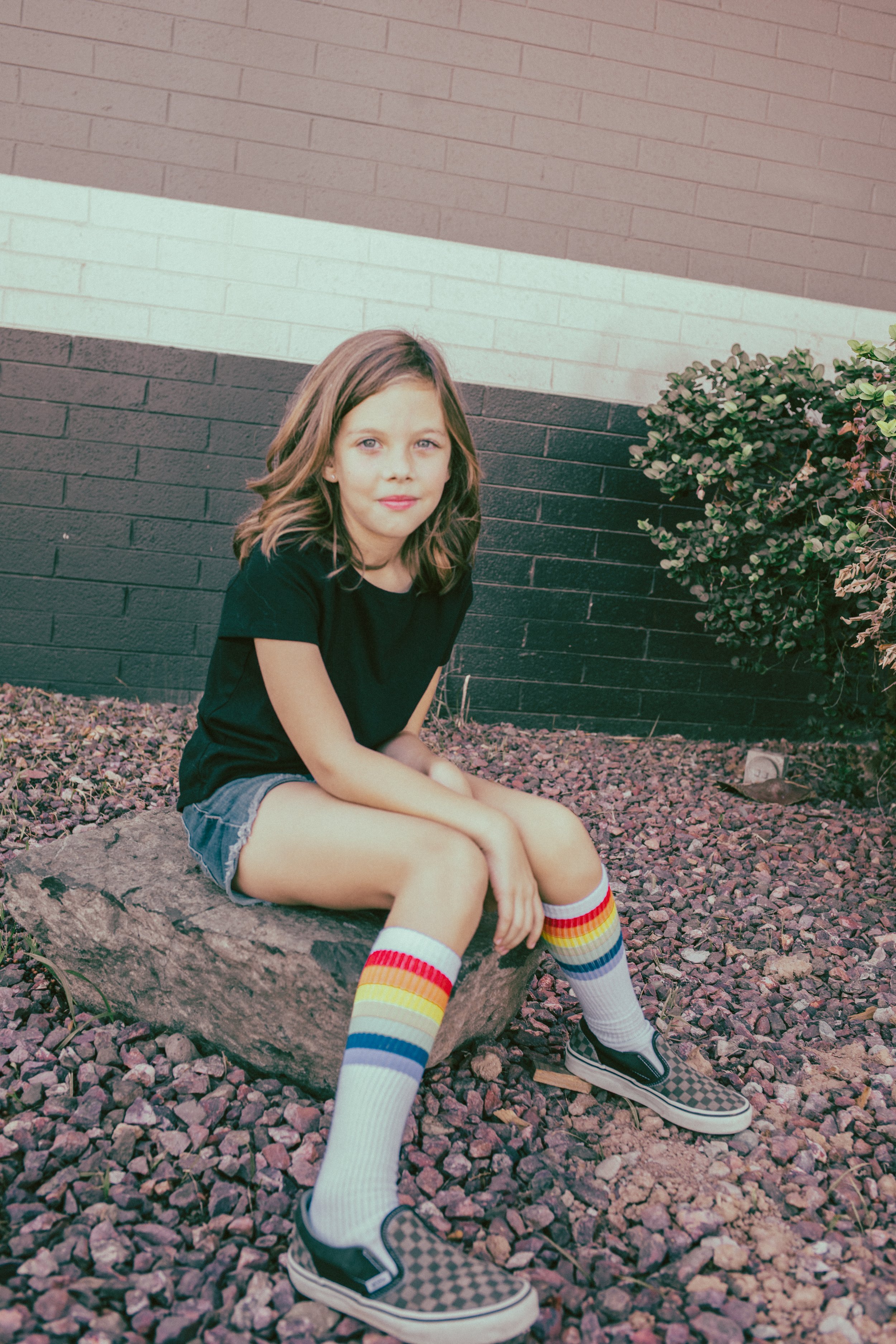 Kids pose for their retro bike and skateboard photoshoot at Bowlero in Phoenix, Arizona by creative family photographer; Jennifer Lind Schutsky.