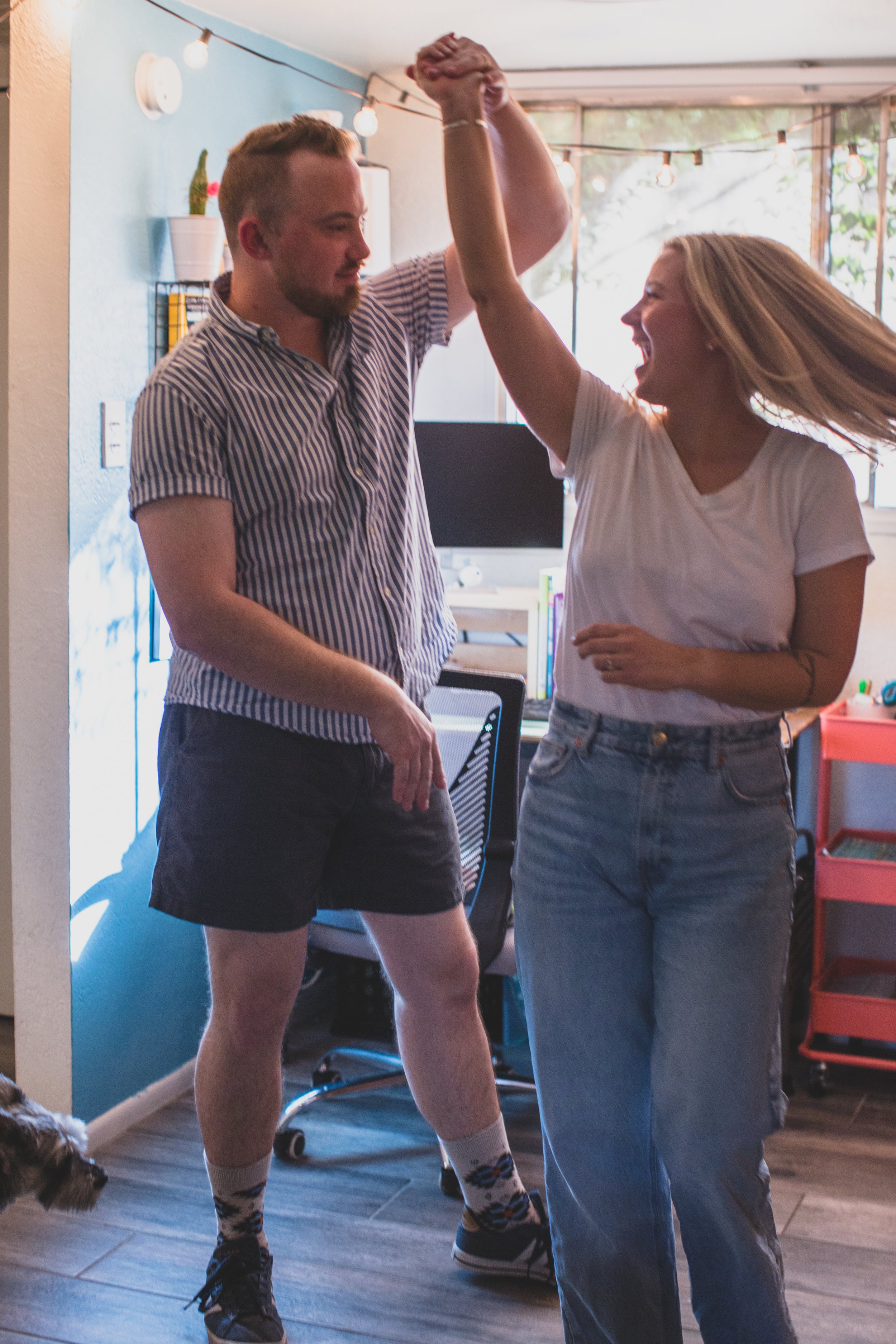 Newly engaged couple dance in the kitchen during their In-Home Engagement Session with Phoenix based intimate engagement photographer Jennifer Lind Schutsky. 