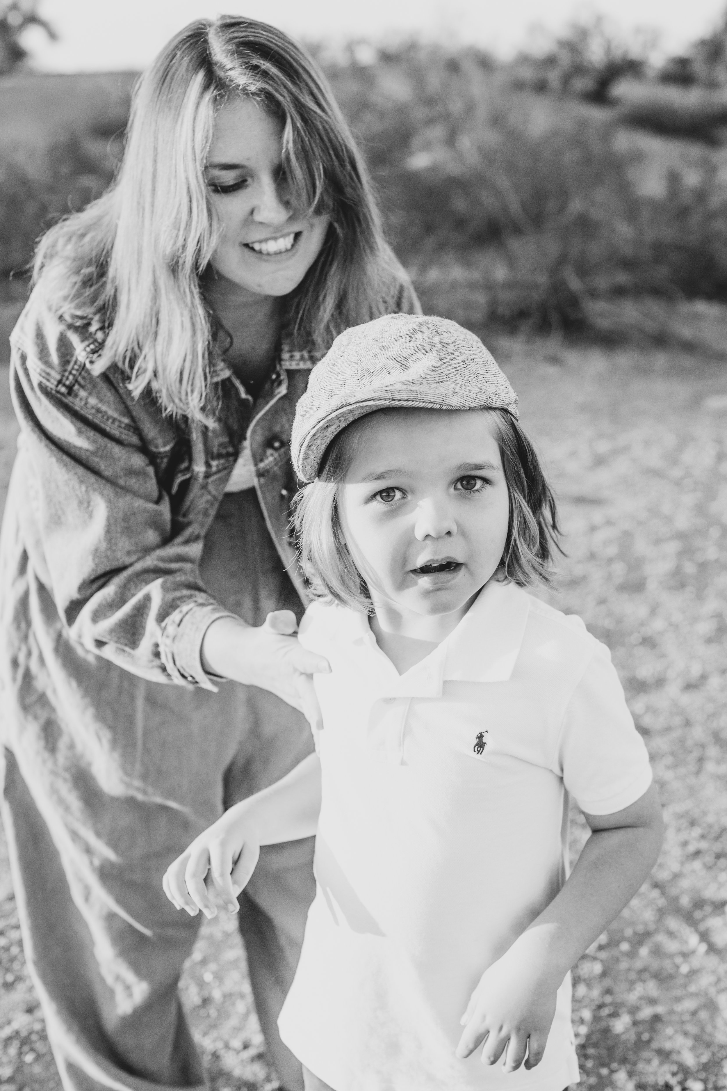 Stylish young kid and mom poses for his family desert photo session near Papago Park in Tempe, Arizona by Phoenix based family photographer Jennifer Lind Schutsky. 