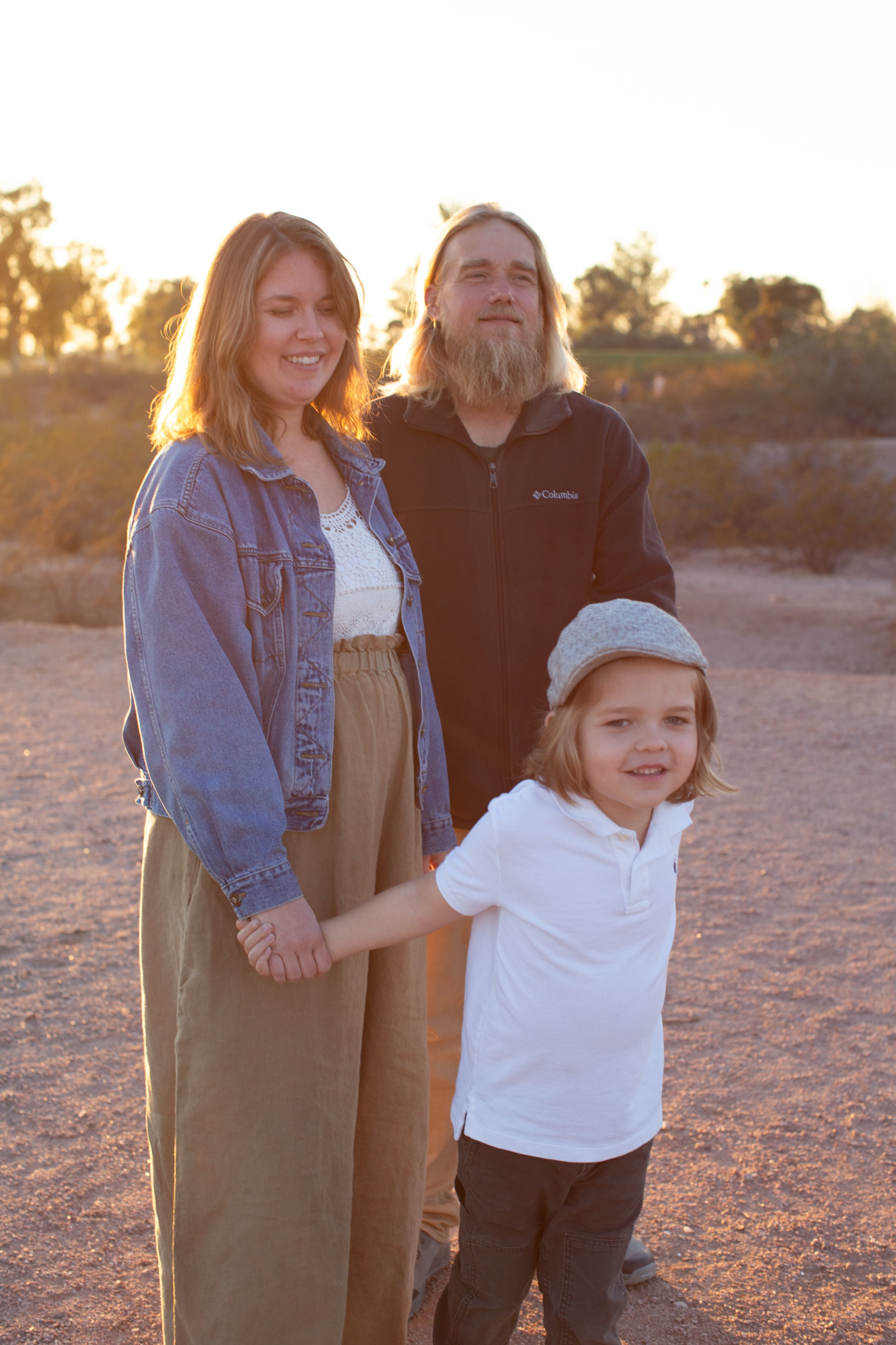 Well dressed casual family poses during family desert photo session near Papago Park in Tempe, Arizona by Phoenix based family photographer Jennifer Lind Schutsky. 