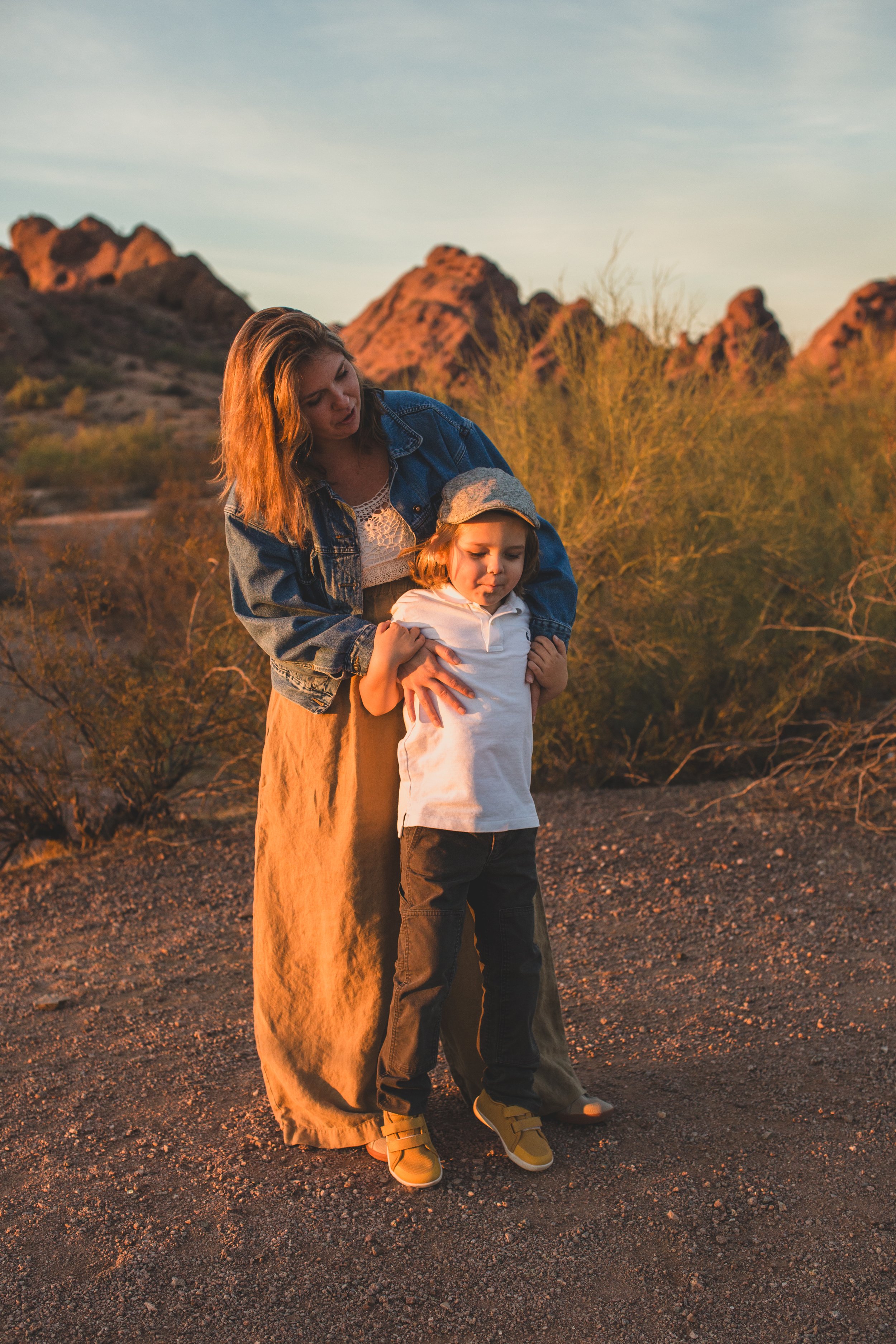 Mother and son playing together during family desert photo session near Papago Park in Tempe, Arizona by Phoenix based family photographer Jennifer Lind Schutsky. 