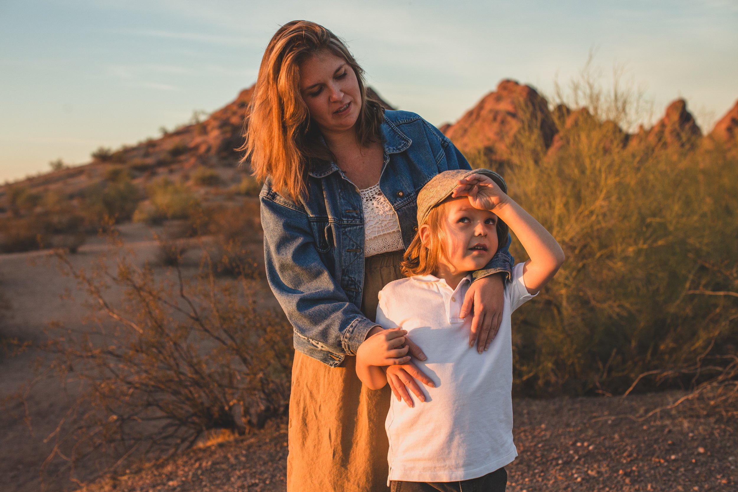 Mother and son playing together during family desert photo session near Papago Park in Tempe, Arizona by Phoenix based family photographer Jennifer Lind Schutsky. 